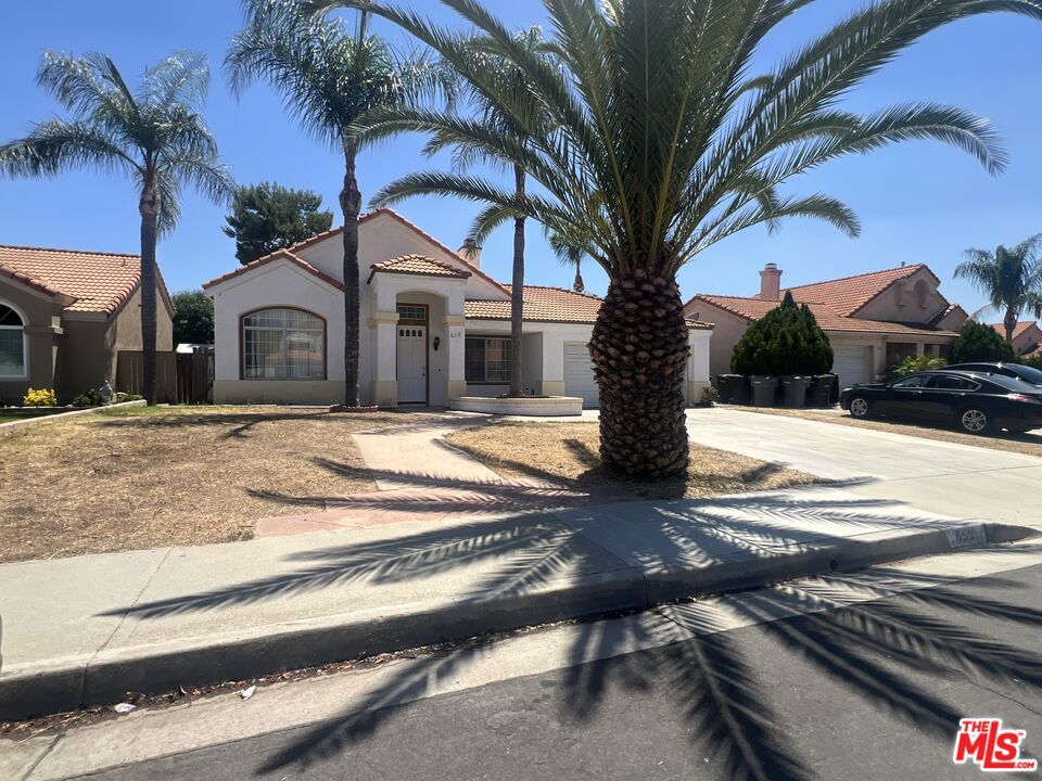 Bright, spacious, and perfectly located! This versatile 3 bed / 3 bath single-story home offers easy living just a short stroll to top-rated schools and minutes from shopping and dining. Soaring ceilings greet you in the living room, while durable tile and laminate floors run throughout for low-maintenance comfort. A roomy, open kitchen flows to an inviting dining area ideal for family meals or game nights. Need flex space? Head up to the airy loft, perfect for a playroom, home office, or studio. Enjoy two true primary suites (one with direct backyard access) plus a third bedroom for guests or kids. Outside, a large private backyard is ready for barbecues, play sets, or relaxing under the stars. The oversized garage features recessed lighting great for projects or extra storage. Available now, move in and start enjoying this convenient lifestyle today!