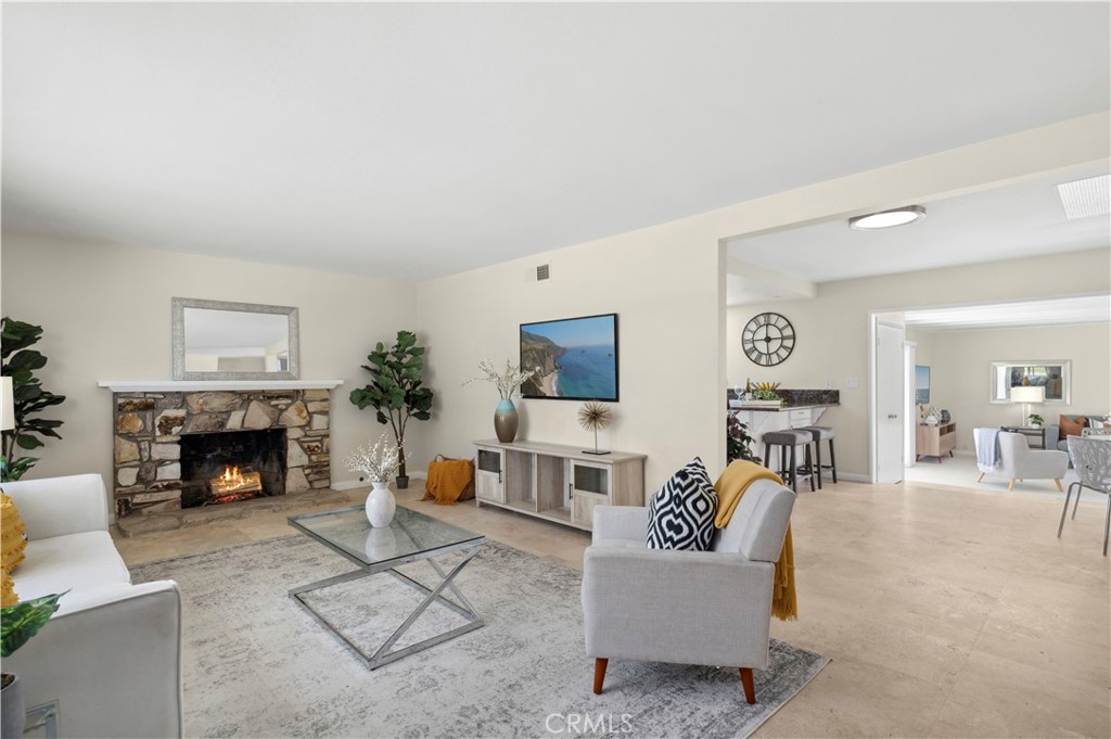 This fantastic home is comfortable, inviting, warm, with an enormous yard, and move-in ready. Light and bright throughout, it's a three-level home with a bedroom on the 1st floor and three more upstairs - an incredibly convenient and functional design. The garage is extra-large with additional storage space and there is plenty of space behind the side gate to park a boat or RV! It is placed in one of the most sought-after neighborhoods in the city. There is nothing on the market like this home - the curb appeal is next level, the condition of the house is top-notch, the layout is spectacular for entertaining - yet has a private, cozy, and intimate feel; and the outside space is SO expansive! And of course, Fountain Valley is one of the most desirable communities in Southern California: the highly-ranked Gisler Elementary is just across the street, Mile Square Park is very close by, and its location is incredibly convenient and central to everything wonderful in Orange County (the beach is less than 5 miles away!). Whether you're enjoying a cozy evening by the wood-burning fireplace in the living room, hanging out in the family room, or dining al fresco on the outside deck, this home has everything you could ever want.