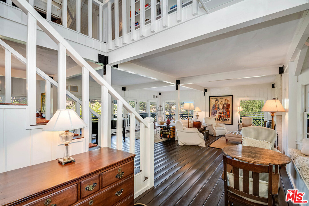 Nestled in a secluded canyon in the Upper Riviera, this enchanting home offers a secluded & tranquil retreat w/stunning canyon & mountain views. Enjoy sophisticated country living in this prime Pacific Palisades neighborhood, yet just minutes away from the bustle of the city. A gated private driveway leads to a motorcourt & charming front porch. Enter into the 2-story foyer & spacious living rm w/fp & walls of windows & doors opening to the wrap-around patio that encompasses the main level. Dining rm & fabulous chefs kitchen w/prof. appliances, island & breakfast rm w/fp. The upper level is comprised of a tremendous master suite w/office/sitting rm, fp, balcony overlooking beautiful views to the Getty, walk-in closet, & spa-like bath w/fp & sauna. The lower level offers 4 addl bdrms, media lounge w/kitchenette/bar, laundry rm & storage space. The lushly landscaped exterior space offers great space for entertaining w/multiple decks/patios including a dining & BBQ area, pool & spa.