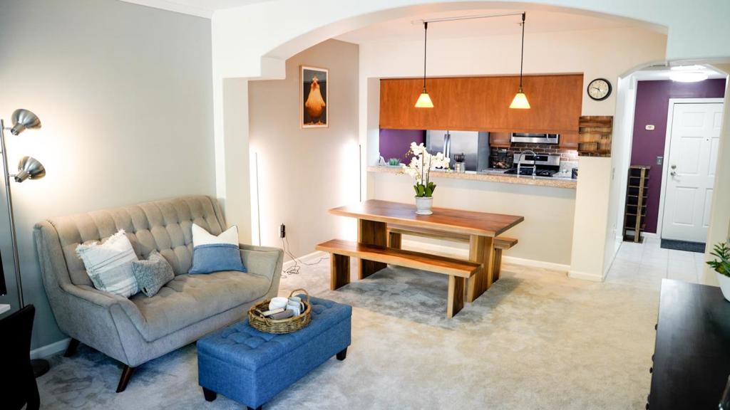 Located in The Plaza community, this stylish, third-floor condo offers an open, light-filled layout with high ceilings, abundant windows, and comfortable carpeting throughout. The spacious kitchen boasts stainless steel appliances, including a refrigerator, gas range with a brick backsplash and smart exhaust switch, and a new dishwasher. It also features a compact pantry and ample cherry cabinet storage, with beautiful glass upper cabinets. Generous counter space is available for food prep and serving, and also has bar seating, all ideal for entertaining. The kitchen seamlessly opens into a bright dining area, illuminated by pendant lighting. The open living space has charming details with floor-to-ceiling accent brick wall with sconce lighting and elegant arched architecture. The primary bedroom is expansive, featuring floor-to-ceiling windows and a large walk-in closet with built-in shelving. The en-suite bathroom has tile shower, large vanity storage, ThinQ W/D. Other features: A/C, Ecobee thermostat, smart locks/electric outlets, and Ring. Community provides secure underground parking with elevator access. Located close to San Pedro Square, SJSU, VTA light rail, and freeways. With its beautiful design and location, this home offers a comfortable and convenient lifestyle.
