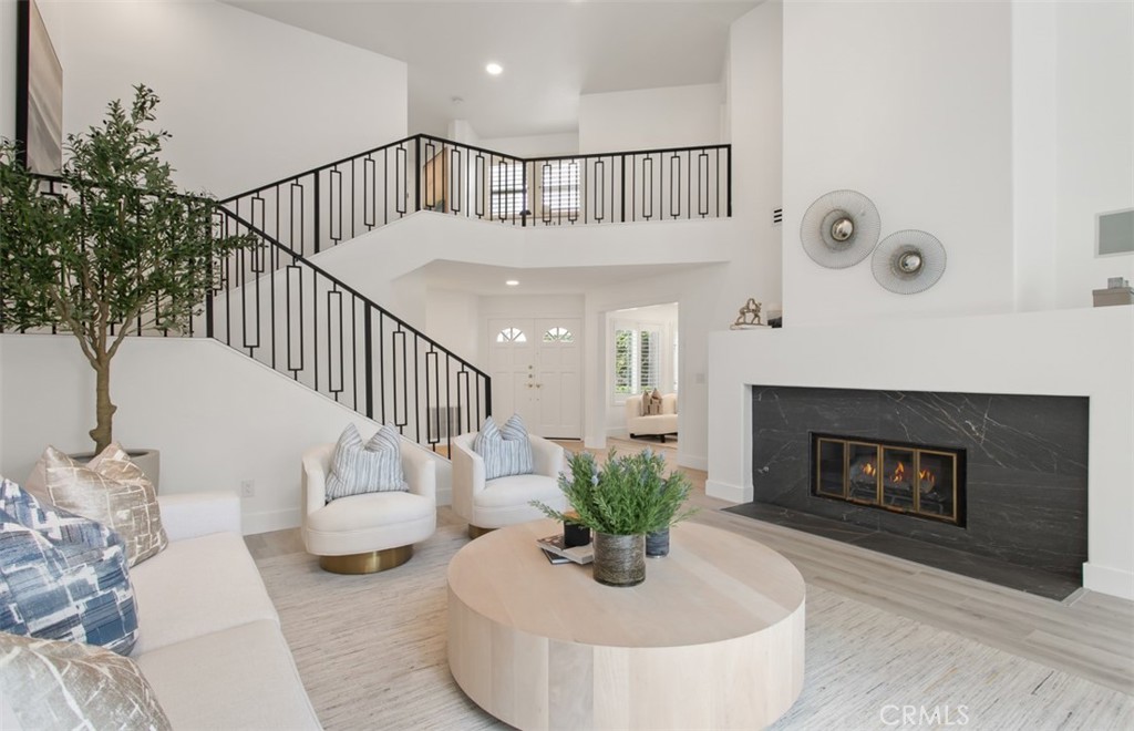 Located within the gates of one of Irvine’s most desirable communities, this extensively renovated home in Turtle Rock Pointe offers a sophisticated blend of comfort, quality, and modern design. Every element of the home has been thoughtfully updated, including a reimagined kitchen featuring custom cabinetry, quartz countertops, stainless steel appliances, and a spacious peninsula island designed to accommodate both daily living and entertaining. The bathrooms have been beautifully renovated with contemporary fixtures, sleek tilework, and premium materials, while brand-new flooring and fresh interior paint provide a cohesive, move-in-ready feel. A custom staircase adds architectural interest and enhances the home's open, airy layout. The primary suite is generously sized and thoughtfully appointed with its own private balcony, a luxurious en-suite bath with a freestanding soaking tub, separate walk-in shower, dual vanities, and a well-organized walk-in closet. Two additional bedrooms and a stylishly updated hall bathroom provide flexibility for guests, family, or a home office, while the additional powder room adds everyday convenience. Additional highlights include a two-car attached garage with new epoxy flooring and a private, low-maintenance backyard—ideal for outdoor dining, lounging, or enjoying the temperate coastal climate. Situated in a prime location with convenient access to major freeways, top-rated schools, UCI, John Wayne Airport, world-class shopping and dining, premier medical facilities, Strawberry Farms Golf Club, and Southern California’s best beaches, this home offers both an elevated lifestyle and lasting value.