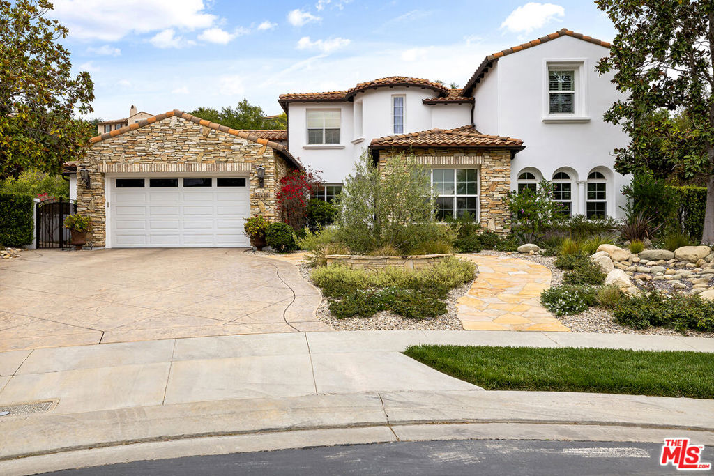 Discover unparalleled luxury in this exceptional home, perfectly situated on a quiet cul-de-sac in the prestigious 24-hour guard-gated community of The Oaks. This property masterfully blends elegant design with superior amenities for both comfortable living and grand-scale entertaining. The open-concept main floor features a gourmet chef's kitchen, equipped with Viking and Bosch appliances, a large center island, and a butler's pantry connecting to the formal dining room. The adjacent family room, with its cozy fireplace and custom built-ins, offers a perfect space for relaxation.The main-floor primary suite is a private oasis, complete with its own patio and fireplace. Its recently remodeled, spa-like bathroom features quartz countertops, dual vanities, and a spectacular custom walk-in closet. Upstairs, three generous bedroom suiteseach with an ensuite bath and walk-in closetsurround a versatile loft bonus room. The home also includes a dedicated office with custom built-ins and a separate gym/dance studio (potential 6th bedroom suite). Step outside to one of the largest and most usable yards in The Oaks, featuring a custom pool and spa with a waterfall and waterslide, a full poolside bathroom, an all-season gazebo with a firepit, and a built-in BBQ island with a fridge, icemaker, and 2-keg kegerator. The oversized lawn provides abundant space for recreation and can easily accommodate a sports court. Residents enjoy access to The Oaks' world-class amenities, including a fitness center, sports courts, community pool, and numerous parks and events. This property represents a rare opportunity for elevated living in one of Calabasas' most sought-after communities. Square footage includes 420 sf gym/dance studio/6th BD-BA with interior access through garage.