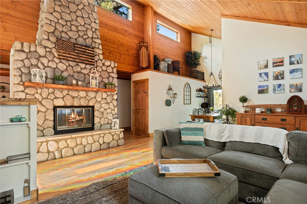 WOW, WOW, WOW!!! This Home Has the Perfect Blend of RUSTIC & MODERN!!! It is ABSOLUTELY STUNNING with Hard Wood Flooring & High Ceilings Throughout, Windows Everywhere Bringing in the Natural Light and Knotty Wood Walls! There is Level Entry into Home with an Inviting Open Floor Plan and a Gorgeous Floor to Ceiling Stone Fireplace! There are 3 Bedrooms and 2 Baths all on the Same Floor Which Makes for SUPER EASY LIVING HERE! Downstairs Apartment is Permitted and Can Be Accessed from the Outside or Down the Stairs from the Main Home. The Apartment is VERY SPACIOUS and OH SO CUTE!!! Adorable Kitchen Includes Full-Sized Refrigerator, Stove and Dishwasher with CONCRETE COUNTERTOPS! Living Room is Cozy with Built-in Bookshelves and French Doors Open to a Private Office. Bedroom and Bath are Tucked in the Back!!! YOU WILL LOVE the AMAZING USABLE FENCED BACKYARD with Grass!! RV/Boat Parking Upfront too!! 2-CAR GARAGE with Additional Parking in the Driveway. This is One of those Special Homes that Rarely Hits the Market. Don't Miss it!!