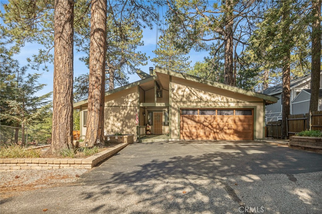 WOW, WOW, WOW!!! This Home Has the Perfect Blend of RUSTIC & MODERN!!! It is ABSOLUTELY STUNNING with Hard Wood Flooring & High Ceilings Throughout, Windows Everywhere Bringing in the Natural Light and Knotty Wood Walls! There is Level Entry into Home with an Inviting Open Floor Plan and a Gorgeous Floor to Ceiling Stone Fireplace! There are 3 Bedrooms and 2 Baths all on the Same Floor Which Makes for SUPER EASY LIVING HERE! Downstairs Apartment is Permitted and Can Be Accessed from the Outside or Down the Stairs from the Main Home. The Apartment is VERY SPACIOUS and OH SO CUTE!!! Adorable Kitchen Includes Full-Sized Refrigerator, Stove and Dishwasher with CONCRETE COUNTERTOPS! Living Room is Cozy with Built-in Bookshelves and French Doors Open to a Private Office. Bedroom and Bath are Tucked in the Back!!! YOU WILL LOVE the AMAZING USABLE FENCED BACKYARD with Grass!! RV/Boat Parking Upfront too!! 2-CAR GARAGE with Additional Parking in the Driveway. This is One of those Special Homes that Rarely Hits the Market. Don't Miss it!!