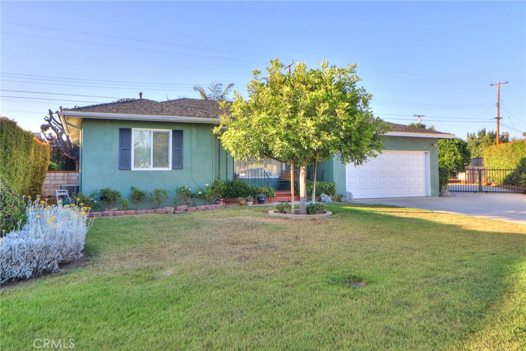Super clean and well-maintained home in a beautiful neighborhood of West Covina. Sits on a 9000+ square foot lot in a prime location. Walk to award winning elementary school... or not ;). This home features a great floor plan with 2 baths and 2 bedrooms. The bigger bedroom is the size of 2 rooms and has a convenient sliding glass door leading out to the back patio. The patio is a perfect spot to relax and perfect for summer dining. The kitchen is bright, clean and it has a small breakfast nook. There is a formal dining room next to the kitchen with recessed lighting and plenty of natural light. Central air and heating make for comfortable winter and summers. Water heater and washer dryer hookups are in garage making more storage space in the home. Fireplace with natural wood mantel and large picture window in the living room. You will love the entrance, the floor plan and old-school charm of some of the early original features. Meticulously maintained 1950's original tile work in one bathroom. Original, never painted beautiful wood doors. Covered parking is in the 2 car garage with direct access into the home. Room for big RV, classic cars or all the toys, 11x34 RV parking off to the side. The backyard has mature fruit trees plus shaded patio for multi-use. There is a quality built wrought iron security gate for RV access. This is one of those homes that will work for the buyer looking to downsize with a large RV or a new young family starting out. There is no need to sacrifice space, privacy or outdoor potential.