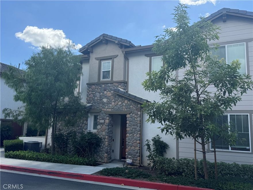 Located in the center of Yorba Linda, right across from Nixon Library, this 2-story home offers a perfect modern comfort of living.  It contains 4 bedroom, 3 bath with 2,067 SF of living space.  Upon entry, you are greeted by an open floor plan. Spacious living room has a fireplace, sliding glass door leading to the patio.  The kitchen boasts shaker style cabinets, granite counter top, built in microwave and oven.  Downstairs also has a one bedroom and one full bath.  Upstairs offers a master suites, another 2 bedrooms, 1 bathroom, laundry room and a loft.  Master bathroom has dual sinks, a separate tub and a shower stall.  Huge walking closet.  There are ample storage space including the linen closet at the upstairs hallway and storage room under the staircase.  Additional notable features are plank and tile floors downstairs, fresh paint, new carpets for the 2nd floor, attached two car garage, and a tankless water heater.  Association amenities include pool, clubhouse, BBQ area, and playground.  Super convenient location, walking distance to Yorba Linda Town Center, library, parks, etc.