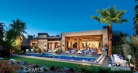 Beautiful contemporary home with unobstructed south views, over the lake and green of BIGHORN'S 6th green of the Canyon's course. Crisp use of colors, high ceilings with walls of glass throughout. Five exquisite guest suites, two of which are contained in a guest house with their own living room and breakfast bar. Master suite and office in close proximity, while the custom theater is near kitchen, wet bar and wine room. Fantastic garage space, with room for 6 cars and a golf cart. Professionally furnished, with upgraded a/v and owned solar.