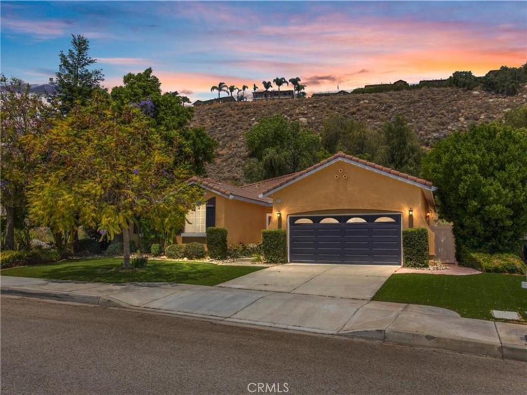 Spacious East Highland home no HOA. The slopped backyard hill has pathways of trees and nature at it's best. Once you get to the top of the property line you have a beautiful hillside deck with built in seating and firepit. Breath and flow through life and be present to experience all life has to offer. You will notice gorgeous views valley and city lights. This home has a popular split floor plan with a primary suite on one side of the home and other 3 bedrooms and bath on the other side. The interior features a Open Floor Plan with recessed lighting and bamboo flooring. The kitchen/family room combo is a must see! The kitchen has granite countertops, backsplash and stainless steel appliances. You will love the kitchen island for extra seating or for creating a focal point for cooking or socializing. The family room has a fireplace for creating a wonderful ambience for all. Do you need a three car garage? Well you are in luck, it has a tandem garage with a pull down staircase for your attic. Too much to list! Call today for your personal tour!