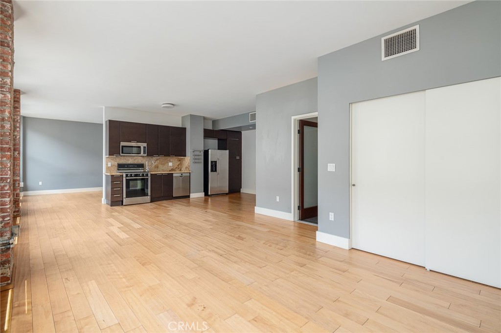 Live the best of DTLA life in this sleek 2-bathroom loft on Spring Street in the iconic Rowan building. This cool loft is one of the few units in the building to have an oversized 2-bedroom floorplan, on tax records, (which is currently set up as one big open loft space with one separated bedroom). The layout is such that the bedroom has been sectioned off as a separate room. It also features 10-foot ceilings, exposed brick walls, top of the line appliances and overlooks 5th Street. The large windows let in luscious amounts of light. The sleek kitchen is open to the living room. There’s a roomy bathroom with shower/tub combo en-suite with the private laundry area. Located in the Old Bank District in the booming Historic Core of Downtown LA, the Rowan was originally built in 1912 and exquisitely remodeled in 2008. Today’s residents enjoy a beautiful mix of historic building features and high-end modern conveniences. Historic features include exposed brick walls, original large windows with beautiful mahogany frames, historic marble flooring in the lobby and restored exterior façade. The Rowan is a full amenity building, including a 24-hour doorman, resident’s lounge, hot and cold plunge pools, outdoor BBQ area, dog run, on-site dry-cleaning valet and bike storage. All common areas are even WIFI-enabled. Parking is available to rent in the adjacent Old Bank District Garage, which is located directly behind the Rowan, and accessed via a partially gated alley.