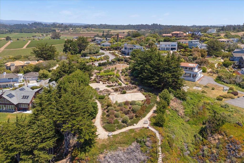 Welcome to one of the most breathtaking properties in all of Santa Cruz County. Perched on a dramatic beach bluff with sweeping ocean vistas, this rare 15+ acre property captures the magic of the California coast. Stroll through lush gardens that feel like a living work of art, with serene pathways, vibrant plantings, and multiple peaceful spaces to relax and take in the views. Currently, part of the land is lovingly cultivated as organic strawberry fields, offering both beauty and the charm of coastal agriculture. From nearly every angle, the property opens up to panoramic scenes of the ocean and surrounding landscape. Multiple view areas invite you to pause, breathe deeply, and experience the tranquility of nature. The possibilities here are endlesswhether creating a private retreat, expanding the gardens, or embracing the lands rich agricultural potential. This is more than a propertyits a lifestyle, a sanctuary, and a rare chance to own a piece of coastal paradise.