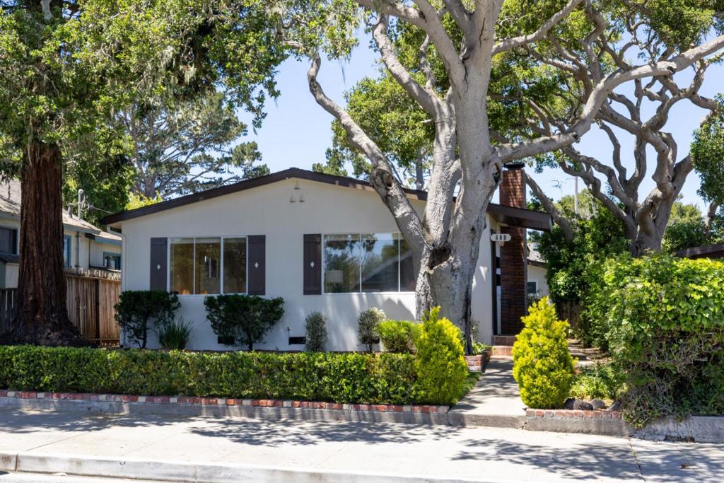 Nestled in the heart of Pacific Grove, this charming single-story property offers a rare street-to-street lot with two-car garage on the alley. The formal front yard welcomes you with a lush green lawn set back under majestic redwood and oak trees. Inside, the clean and bright main house is approximately 1,140 sq.ft., well-maintained and updated with new flooring, quartz counters and stainless appliances, featuring 3 bedrooms, 1.5 bathrooms, a cozy living room with fireplace, dining area, and indoor laundry. A separate 1-bedroom, 1-bathroom home, approximately 596 sq.ft., offers an ideal space for guests, rental income or multigenerational living. Recently renovated in 2023, this retreat boasts new windows, recessed lighting, remodeled kitchen with new counters, cabinets, stainless appliances and luxury vinyl flooring. Each unit of this fantastic duplex has new electrical panels, separate meters, separate laundry areas, direct access to one dedicated garage space and plenty of extra storage. Enjoy a quaint central courtyard with garden and privacy hedges, perfect for pets, play or relaxing outdoors. Just minutes from schools, downtown and the beach, this is a unique opportunity to own a versatile, move-in-ready property in one of the Peninsula's most desirable locations.