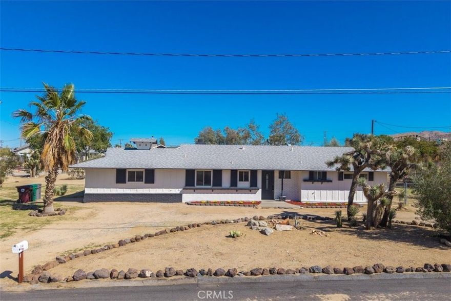 This fully remodeled three bedroom two bathroom home blends modern comfort with desert charm on nearly half an acre, offering both privacy and convenience—just minutes from shopping, dining, and all the amenities of central Yucca Valley.

The home is listed as a two-bedroom, two-bath on tax records but shows as a three-bedroom, two-bath with a flexible layout that fits many needs. Inside, the remodel shines with updated finishes, bright and welcoming spaces, and a seamless flow between living areas.

The exterior is just as inviting, featuring two separate driveways: a circular drive in the front for easy guest access and a side drive that connects to the cul-de-sac—perfect for RV or extra parking. The backyard has a smaller fenced area ideal for pets and children, while the rest of the property remains wide open for future possibilities such as gardens, outdoor entertaining, or additional improvements.

This property offers the rare combination of a move-in ready remodel, a spacious lot, and a desirable Yucca Valley location—an ideal desert retreat.