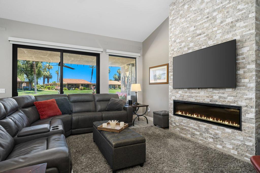 Introducing Your Dream Home in Sunrise Country Club, Rancho Mirage, CAStep into luxury with this stunning, fully renovated corner unit condo, perfectly situated in a quiet cul-de-sac within the highly sought-after Sunrise Country Club. Located in iconic Rancho Mirage, CA, this inviting residence has been meticulously updated, designed to embrace comfort and style.**Features You'll Love:**- **Breathtaking Views:** Enjoy the serene views of the 8th hole of the Sunrise Golf Course right from your back patio, complete with a pony wall for added privacy.- **Spacious Living:** This 3-bedroom, 2-bathroom condo showcases the popular Barcelona floor plan, thoughtfully modified by converting the atrium into a chic wet bar, creating the perfect entertainment area between the living and dining areas.- **Chef's Delight Kitchen:** The opened-up kitchen is a cook's dream, featuring elegant light quartz countertops, a gas cooktop, stainless steel appliances, and a scenic corner of windows that let in natural light and offer stunning views.- **Cozy Evenings:** The living area is complemented by a state-of-the-art electric fireplace, ensuring warm and cozy evenings.- **Modern Upgrades:** Experience stylish ceramic tile flooring throughout, with both bathrooms fully updated with quartz counters and zero-threshold walk-in showers.- **Convenient Office Space:** The third bedroom is currently set up as a functional home office, perfect for remote work or study.- **Ample Storage:** The well-appointed laundry room offers plenty of storage, alongside an attached garage for your convenience.- **Energy Efficiency:** Benefit from the cost-saving features of owned solar panels, a tankless water heater, double-paned windows, and automatic blinds.**Community Perks:**Situated across the street from a community pool and spa, you're ideally positioned to relax and unwind. Sunrise Country Club is celebrated as the friendliest club in the desert, offering an array of amenities, including a state-of-the-art fitness center, an 18-hole golf course, and 14 tennis & pickleball courts. Flexible membership options are available to suit your lifestyle.This exceptional condo is more than just a home--it's a lifestyle opportunity in the heart of Rancho Mirage. Don't miss your chance to make it yours! Contact us today for a private tour.