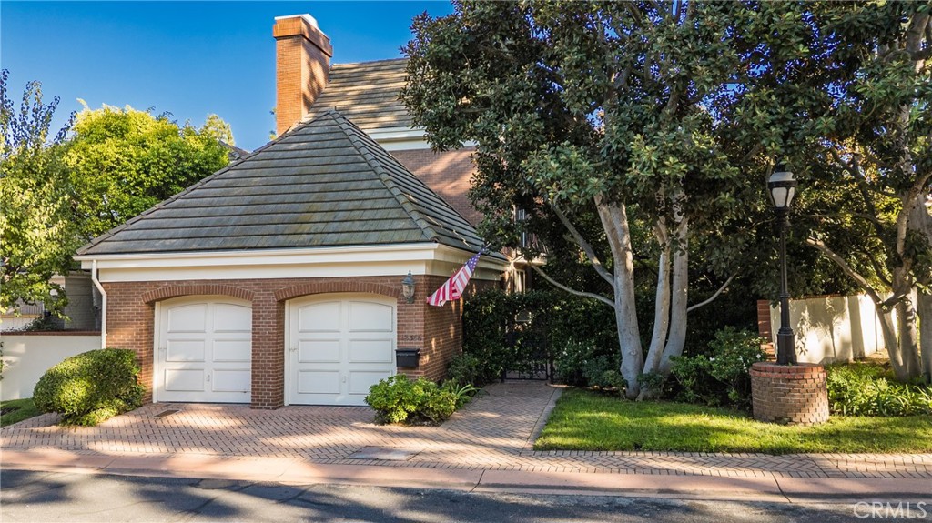 This exceptional 3-bedroom, 4-bathroom 4,018 square foot corner townhome delivers resort-style living in the highly desirable guard-gated Ridge area of Mountain Gate in Brentwood Hills. Located in a very secluded area with 24 hr. security and unmatched serenity. Stanley Kramer, American Film Director, was the original owner of this property set behind a private iron gate with a beautiful courtyard offering complete privacy with only one common wall. This lavish home boasts a formal entry, dramatic staircase, expansive living room with fireplace, wet bar, soaring vaulted ceilings, floor-to-ceiling luminous windows, and elegant French doors displaying a well-manicured wrap-around yard and patios that are perfect for entertaining or quiet relaxation in a zen-like atmosphere with mature trees and koi pond. Spacious eat-in kitchen featuring Miele refrigerator, Wolf dual-convection ovens, Bosch dishwasher, two walk-in pantries and center island. The kitchen has easy access to the formal dining and living areas. One bedroom with ensuite bathroom is conveniently located on the first floor. Additional highlights include a library with fireplace and its own private patio, a dedicated laundry room and a double-attached garage with direct access to the home. Upstairs, retreat to an over-sized luxurious primary suite with a sitting area and a private Juliet balcony with tree-lined views. A huge spa-like bath offers a soaking tub, dual vanities, and a separate shower and bidet. Separately located upstairs is a private 2nd bedroom that has easy access to a full bath. The HOA includes community Pool/Spa, Trash Valet, exterior EQ and Fire Insurance as well as roof coverage. You will have the option to join Mountain Gate Country Club that offers golf, tennis, spa and dining. Easy 405 Freeway access, shopping, dining & spectacular hiking trails. Enjoy the tranquil, resort-like lifestyle and make this stunning colonial-style home yours. Call for a private showing.