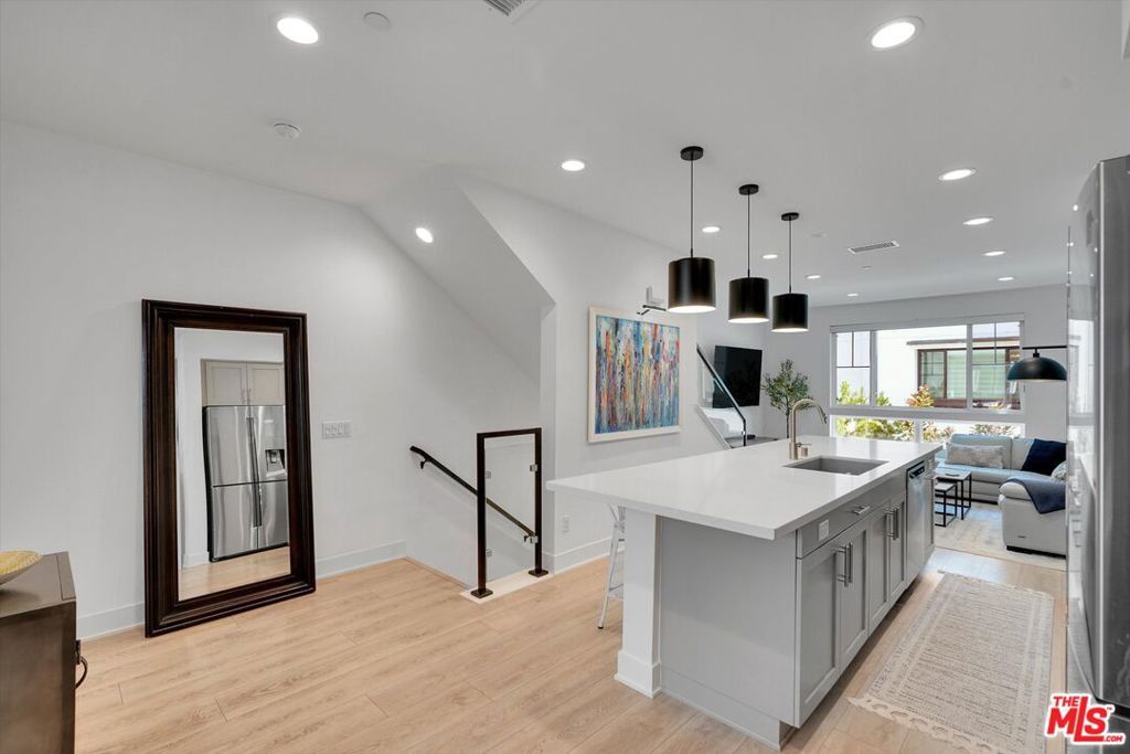 Welcome to your new home at Expo Walk, a prestigious gated complex designed by award-winning KTGY Architecture, located in desirable Leimert Park. This community offers the perfect blend of luxury and convenience. This stunning multilevel townhouse features a modern layout with 2 spacious bedrooms with ensuite bathrooms and a dedicated laundry room upstairs; an open floor plan kitchen and living room, a versatile den perfect for a home office, and a powder room on the first floor. The main entrance and private garage are located on the entry level, providing ample storage and ease of living. Expo Walk offers excellent connectivity, being close to the highway and just steps away from the Expo/Crenshaw Metro Station. With the existing metro line, you can easily travel to Santa Monica and Downtown, and soon the metro station will provide direct transit to LAX. This ensures a convenient commute and easy access to various parts of the city, making it an ideal location for those who value both accessibility and tranquility. The community features a pocket park with two professional grills, two fire pits with plenty of seating, a ping-pong table, and two dog runs. Don't miss out on this exceptional opportunity to own a piece of luxury in one of the most sought-after locations. Schedule a viewing today and experience the perfect blend of comfort and convenience at Expo Walk. Enjoy the best of both worlds with this prime location that combines the tranquility of a gated community with the vibrancy of city life. All the furniture is also available for purchase separately.