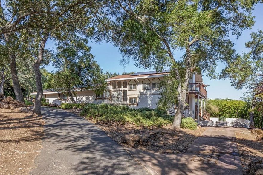 Views of Mt. Hamilton with a spacious dramatic floorplan. Enter your foyer, tall ceilings and easy stairs to your main level. Archway accents to your formal dining room. Dramatic fireplace anchored by two doors and multiple windows. Peaceful country living, wildlife abounds. Birdseye level views off your breakfast room opening to more incredible views. A remodeled kitchen from a few years ago still current in its design. Home has two wings, perfect for extended family or teenagers. Primary wing has 3 bedrooms, large remodeled hall bath with 2 sinks. Primary bedroom has sliding door to outdoor sanctuary deck and a remodeled bath with double sinks.  Laundry room conveniently off this wing.  Family room wing has bedroom, bathroom, and large multipurpose family room - current owner used as a music room. Family room has built in cabinets and sink area - and is large enough to split into 2 purposes - think hobby room, dance room, craft room. Family room fireplace. Solar, EV Charging, Air conditioning. Yard has large private deck space, garden area, side courtyard patio area, tons of extra off street parking. Circular driveway. Park 14 vehicles on 3 parking areas - not including the attached garage. Beautiful views from the main living floor! Lots of entertaining areas and large lot.