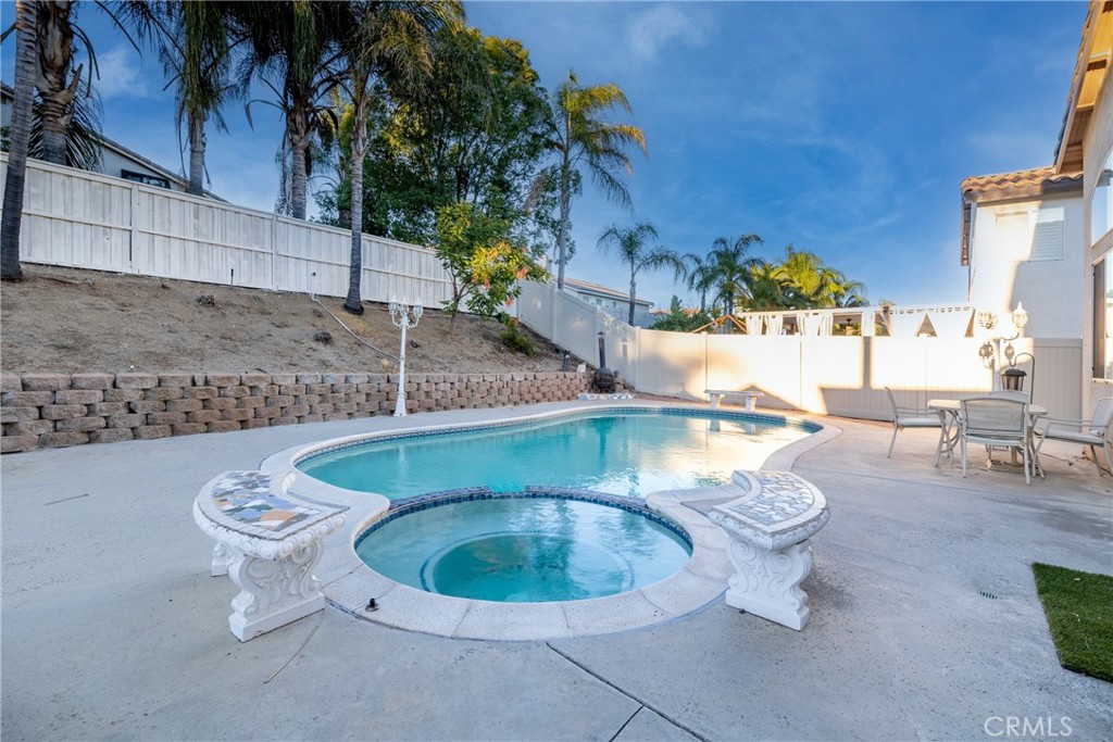 Discover the perfect blend of luxury and comfort at 20858 Bakal Dr, a meticulously maintained 4-bedroom, 2.5-bathroom, 2,621 sq ft retreat in the highly sought-after Orangecrest neighborhood. With no HOA, low taxes, and proximity to top-rated schools, parks, and shopping, this home offers an ideal lifestyle for families and commuters alike, with easy access to major freeways. Step into a grand foyer with soaring vaulted ceilings, opening to a spacious living room and formal dining area with tons of natural light. The heart of the home is the gorgeous kitchen, featuring sleek granite countertops, stainless steel appliances, a breakfast bar, and ample storage—perfect for culinary enthusiasts. The kitchen seamlessly flows into a cozy family room with a fireplace and a bright nook. A convenient half bath, separate laundry room, and direct access to the 3-car garage complete the main level.
Upstairs, the expansive primary suite overlooks the serene backyard oasis, boasting a luxurious en-suite bathroom with dual sinks, a walk-in shower, a soaking tub, and a generous walk-in closet. Three additional bedrooms offer versatility, with the oversized fourth bedroom perfect as a game room, office, or bonus space. A second full bathroom with dual sinks ensures convenience for family or guests. The backyard is a true entertainer’s dream, featuring a custom pool, separate spa, and built-in BBQ, creating a resort-like retreat for family gatherings or relaxation. A charming front porch pond adds unique curb appeal, while the private, peaceful lot enhances the home’s tranquility. With custom tile flooring, an open and versatile floor plan, and no detail overlooked by the owner, this home is move-in ready. Don’t miss your chance to own this Orangecrest gem—your dream home awaits!