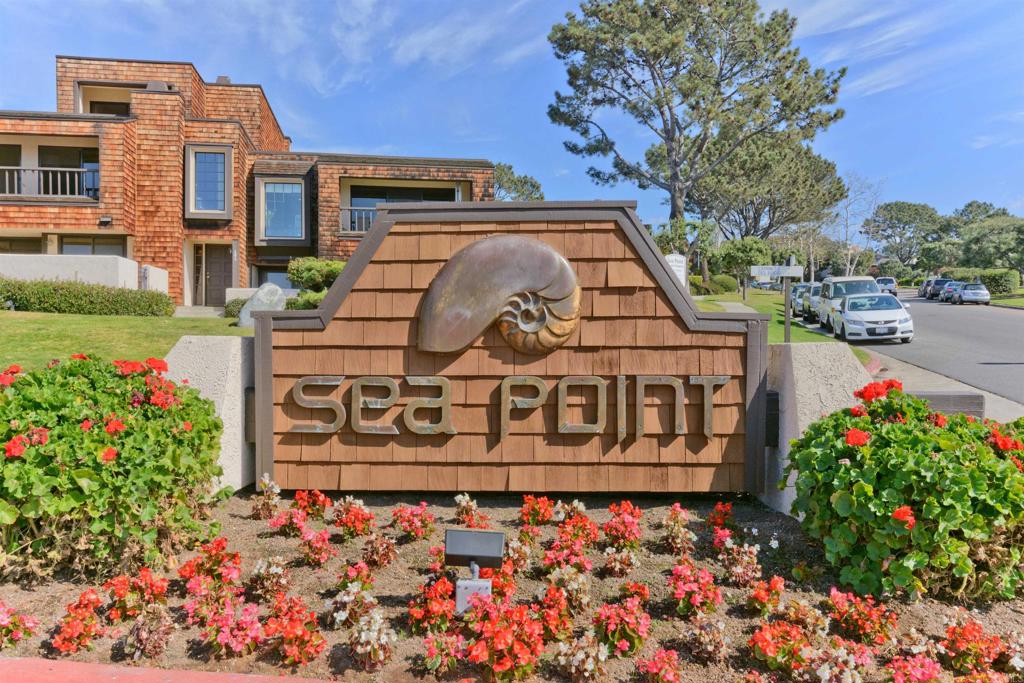 SEAPOINT 3 BEDROOM + OFFICE/DEN IN DEL MAR WITH OCEAN VIEWS!! Prime location near the beach, tennis courts, two pools, community center, and a dog park. Spacious primary suite featuring stunning ocean views, a cozy fireplace, ample closet space, and extra storage. The kitchen is equipped with stainless steel appliances, including a dishwasher, fridge, and oven/range, all in an open-concept layout. Fresh new carpet in the second and third bedrooms, lower stairway and den/office. The office/den can serve as an optional fourth bedroom but does not have a closet. Expansive outdoor patio for relaxation. The living room boasts a wall of sliding doors that open to breathtaking views and refreshing ocean breezes. The dining area is filled with natural light and includes custom built-ins, perfect for entertaining. Enjoy alfresco dining and sunsets on the spacious deck off the living room. Attached two-car garage with additional storage space.