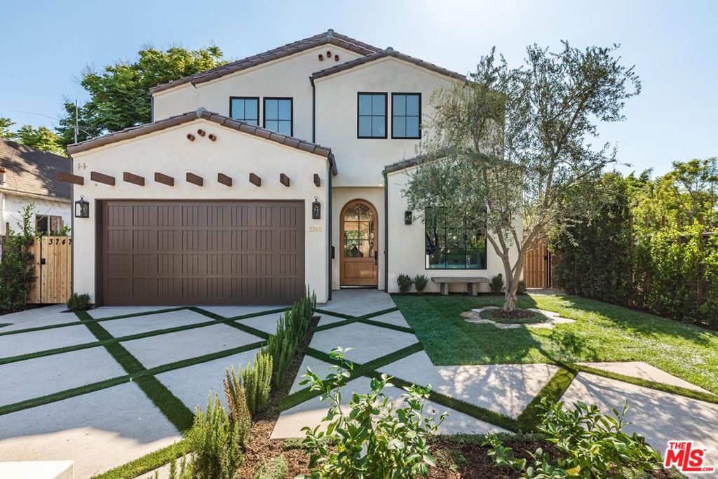 Newly completed Spanish Coastal Transitional showcasing quality craftsmanship, immaculate design, and indoor-outdoor living in one of the most sought after neighborhoods of Mar Vista. Built and designed by Bespoke Homes California, this custom new construction offers 5 bedrooms, 6.5 bathrooms and 3,871 SF of living space including a detached 406 SF ADU. The main floor welcomes you with elegant arched entries, abundant natural light, and oak engineered hardwood floors throughout. The designer-done chef's kitchen is a true statement featuring custom cabinetry, a tiled backsplash, and an oversized island with seating perfect for family gatherings. Beautiful oversized Thermador appliances with double sinks and double Bosch dishwashers. A formal living room, spacious dining room, expansive family room with stone fireplace, powder room finished with Portola paint, and versatile en-suite bedroom ideally suited for an office complete the main level. Expansive sliding glass doors open to a spacious and private turfed backyard with a built-in outdoor kitchen and patio. The detached ADU - with a kitchenette, full bathroom, skylights, and large glass slider provides flexible space for guests or a creative studio. Upstairs, the large primary suite boasts wood beam vaulted ceilings, a plastered fireplace, a breakfast bar/fridge, generous walk-in closet, and a stunning spa-inspired bath with soaking tub. Three additional ensuite bedrooms all baths with their own curated design, a well-appointed upstairs laundry room, and large skylight complete the upper level. Beautifully landscaped with mature privacy hedges, lemon and olive trees w/ stone bench, this exceptional property sits in a safe, quiet, and highly desired Westside neighborhood just minutes from top schools, dining, shopping, and the heart of downtown Mar Vista.