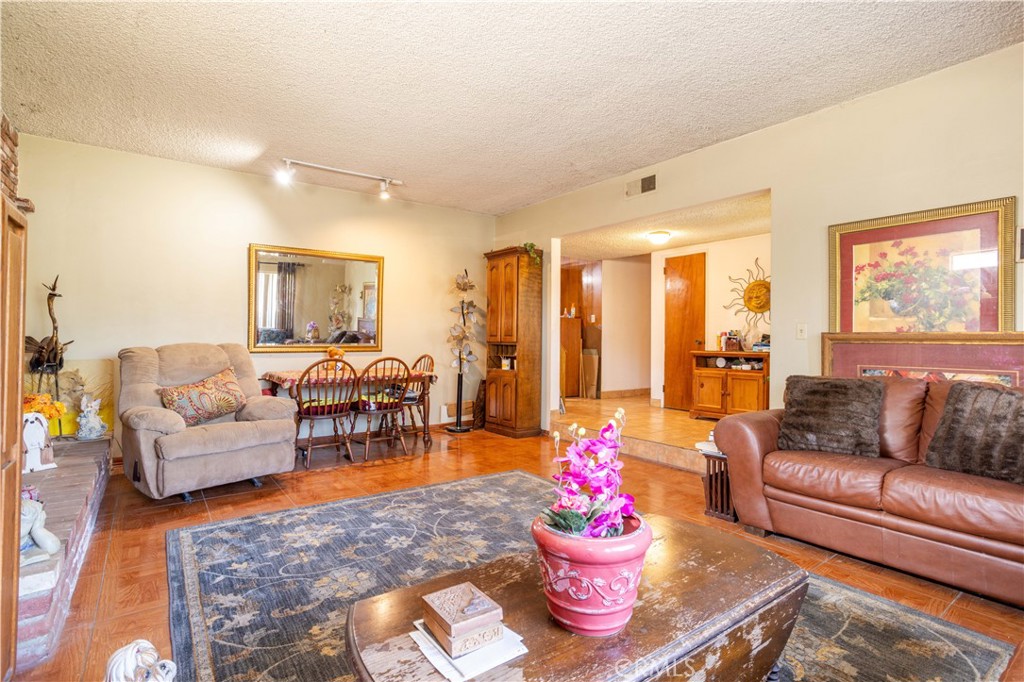 This value priced home is located in a Northridge adjacent North Hills West neighborhood, and with its “Great Bones” it’s the perfect candidate for a value increasing make-over. Here are a few of its other features: Double doors open to a flowing 1,736 square foot floor plan with easy care tile flooring. The spacious living room is bathed in natural light from a large picture window and has a floor-to-ceiling gas-burning brick fireplace with raised hearth. The family’s cook will appreciate the kitchen’s abundant cabinets, tile counters, and built-in appliances. Since the combination dining/family room with its lighted ceiling fan and direct enclosed breezeway access flows seamlessly with the kitchen you’ll find it easy to serve and entertain your guests simultaneously. All 4 bedrooms have efficient ceiling fans; The main suite has 2 roomy mirrored closets and a private bathroom. A total of 2 bathrooms. Central heat. You’re going to enjoy the backyard’s lush privacy landscaping. The 2 car detached garage is the perfect candidate for an ADU conversion. All of this sits on a large 7,440 square foot lot that is close to restaurants, shopping, and minutes away from CSUN, Northridge Fashion Center, and the 118 & 405 freeways. So here is your chance to save thousands by investing in some “Sweat Equity” and turn this “Diamond-In-The-Rough” into your personal gem. Call me today for all the details and I’ll gladly arrange your private tour