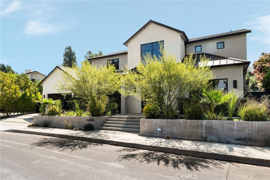 Welcome to this exquisite 5 bedroom, 7 bathroom estate, where modern luxury meets effortless sophistication. Nestled in prime Encino Hills on a tranquil cul-de-sac, this home is zoned for the highly sought after Lanai Elementary School. Thoughtfully designed with a timeless aesthetic, it features Venetian plaster, warm wood floors, custom finishes, and an open layout with soaring ceilings that enhance the sense of space and grandeur. The seamless indoor-outdoor flow leads to beautifully landscaped grounds, complete with a fire pit, BBQ island, and a sparkling saltwater pool and spa with a waterfall—an entertainer’s dream. The primary suite is a true sanctuary, offering a private fireplace, an oversized balcony, and a custom walk-in closet with an island. The spa like bathroom is designed for relaxation, featuring a soaking tub, dual sinks, and an enclosed glass steam shower. Each secondary bedroom is ensuite, boasting soaring pitched ceilings and elegant finishes. Designed for both luxury and convenience, this home includes a state-of-the-art movie theater, a stylish bar and game room overlooking the pool, and two laundry rooms. The chef’s kitchen is fully equipped with top-tier stainless steel appliances, a Wolf gas range, Sub-Zero refrigerator and freezer, double ovens, double islands, a walk-in pantry with an extra refrigerator, and a butler’s pantry. The formal dining room is a showstopper, adorned with designer wallpaper ceilings and complemented by a temperature-controlled wine cellar. Additional features include a Control4 Smart System, designer light fixtures, custom carpentry, and tankless water heaters. This exceptional property must be seen in person to fully appreciate its high-end details. Can also be sold furnished for a turnkey luxury experience.