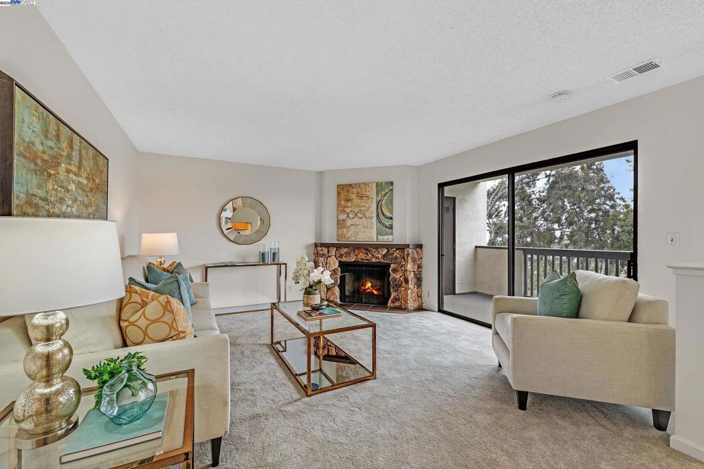 Price Adjustment!!! Welcome to this beautifully maintained 1-bedroom, 1-bath condo in the desirable Mesa Verde community! This 812 sq. ft. ground-level, single-story, level-in unit offers no stairs, making it ideal for those seeking easy access and comfortable living, potentially wheel chair accessible. Step inside to a bright and open floor plan featuring a spacious living area with a cozy fireplace, a dining nook, and a private patio with views of the hills and city lights—perfect for relaxing or entertaining. The kitchen includes ample cabinet space and a breakfast bar, while the large bedroom offers generous closet space and natural light. Enjoy in-unit laundry, dedicated parking, and access to resort-style amenities including a pool, spa, clubhouse, tennis courts, and fitness center. Located just minutes from CSU East Bay, BART, shopping, and major freeways, this home is perfect for buyers looking for convenience and tranquility. Don’t miss this rare opportunity to own a street-level unit with no stairs in a secure, well-maintained community. The HOA covers essential utilities such as water, trash, and sewer, this home is an excellent opportunity for both homeowners and investors.