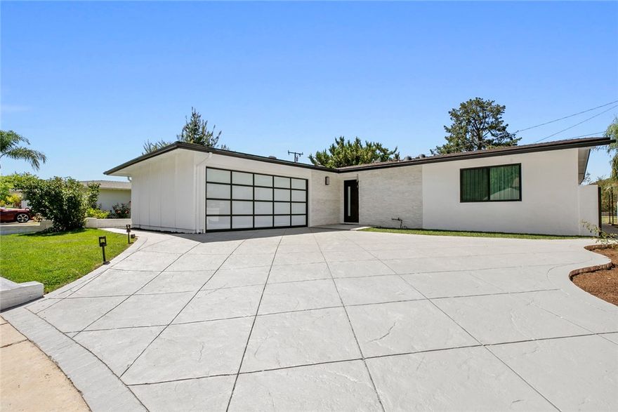 ** Very Motivated Seller** Nestled at the end of a tranquil cul-de-sac in the desirable community of Calabasas, this exquisite single-story residence offers an unparalleled sense of privacy and warmth, accentuated by stunning panoramic mountain views. The home's refined European-inspired design aesthetic is evident in every carefully curated detail. The heart of the home is its custom-designed kitchen, featuring sleek, European-style cabinetry crafted from MDF with a sophisticated combination of laminate and matte lacquer finishes. Premium hardware and luminous white marble countertops and backsplashes create a space that is both visually elegant and exceptionally functional. This commitment to luxury extends to the bathrooms, where floors and walls are adorned with the timeless beauty of Calacatta Gold marble, imported from Italy. The home’s modern aesthetic is further enhanced by matte lacquered, frameless interior doors, which feature concealed hinges and magnetic handles for a seamless and sophisticated appearance.
Both bedrooms and the hallway are equipped with integrated, contemporary European-style closets complete with interior lighting, offering ample and stylish storage. Engineered hardwood flooring flows cohesively throughout the residence, adding a touch of warmth and refinement. A focal point of the living area is the elegant fireplace, distinguished by its half-inch-thick, pencil-cut natural stone surround. Adjacent built-in shelving with dimmable LED lighting provides a perfect showcase for art and treasured belongings. Situated in a prime Calabasas location, this property affords convenient access to a wealth of amenities. Enjoy a scenic 20-minute drive to the world-renowned beaches of Malibu or explore the numerous natural hiking trails within Malibu Canyon. Furthermore, the residence falls within the acclaimed Las Virgenes Unified School District, with A+ rated Lupin Hill Elementary, A.E. Wright Middle School, and Calabasas High School all located within a one-mile radius. 
"The house was designed exclusively by Phase Interiors." " Available for immediate occupancy with a complete, brand new furniture package"