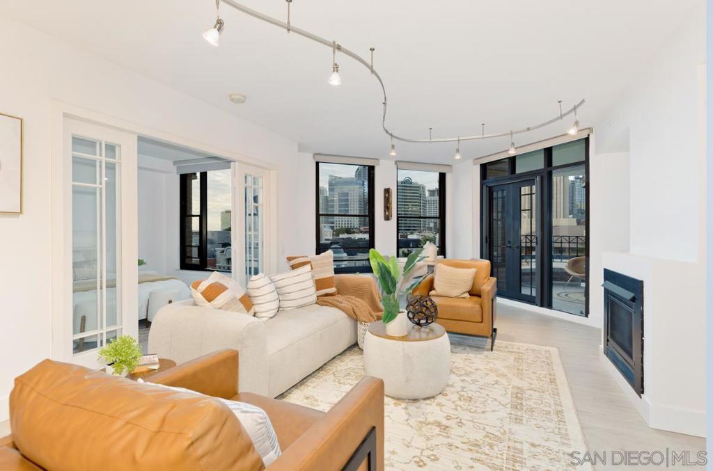 Welcome to Residence 713 at CityFront Terrace—an impeccably upgraded 2BR/2BA home perched on the 7th floor of one of Downtown San Diego’s most iconic buildings. Recently refreshed with brand new flooring and paint, this stunning home blends contemporary finishes with architectural charm. The kitchen has been completely opened up and reimagined with sleek, self-opening cabinetry, high-end appliances, and a dramatic backlit onyx slab under the bar seating—perfect for entertaining or everyday luxury. The open layout flows into a light-filled living space, with the guest bedroom that can double as an office and the primary suite boasts a truly massive closet rarely found in condo living. CityFront Terrace is a full-service luxury community in the heart of the Marina District, known for its historic brick facade and unparalleled amenities including valet parking, two pools (a 75’ lap pool and a splash pool), a 3,500 sqft fitness center with yoga room, the Citrus Room resident lounge, and an on-site staff of 30+. Just steps from the waterfront, Seaport Village, and the Gaslamp Quarter, this is Downtown living at its finest.