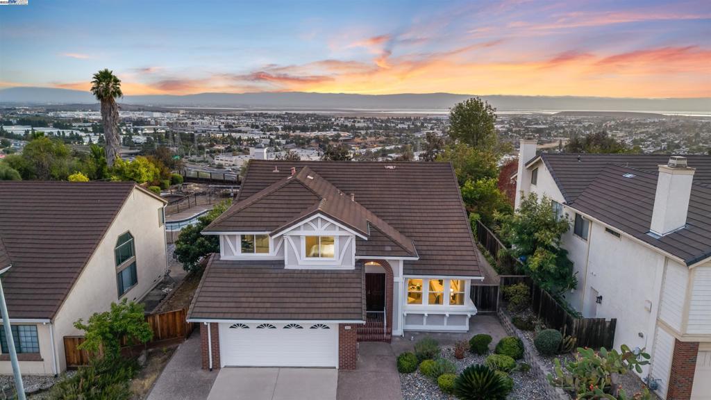 Experience elevated living in this exquisitely remodeled Mission San Jose home, offering 2,668 sq ft of luxury on a nearly quarter-acre flat lot with unobstructed Bay views. Nestled in a quiet court, this 4-bed, 3-bath gem blends elegance and modern comfort. The versatile layout includes 1 bedroom and a fully remodeled bath on the main level—ideal for guests or multigenerational living. The chef’s kitchen impresses with custom Thomasville Martha Stewart cabinetry, quartz counters, full backsplash, premium stainless appliances, and a wine cooler. An open-concept family room captures sweeping views, while soaring ceilings in the living room, formal dining, and primary suite add grand appeal. Upstairs, the expansive primary suite offers motorized shades and an updated bath with dual vanities, walk-in shower, and a Roman-style soaking tub. Upgrades include new carpet upstairs, split-zone A/C & heating, newer dual-pane windows, and fresh interior/exterior paint. Outside, enjoy a sparkling pool, spa, and low-maintenance landscaping perfect for entertaining. Attend top-rated Mission San Jose schools with easy access to 680/880 and major tech hubs.