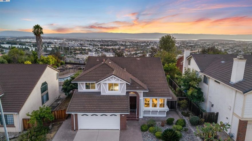 Experience elevated living in this exquisitely remodeled Mission San Jose home, offering 2,668 sq ft of luxury on a nearly quarter-acre flat lot with unobstructed Bay views. Nestled in a quiet court, this 4-bed, 3-bath gem blends elegance and modern comfort. The versatile layout includes 1 bedroom and a fully remodeled bath on the main level—ideal for guests or multigenerational living. The chef’s kitchen impresses with custom Thomasville Martha Stewart cabinetry, quartz counters, full backsplash, premium stainless appliances, and a wine cooler. An open-concept family room captures sweeping views, while soaring ceilings in the living room, formal dining, and primary suite add grand appeal. Upstairs, the expansive primary suite offers motorized shades and an updated bath with dual vanities, walk-in shower, and a Roman-style soaking tub. Upgrades include new carpet upstairs, split-zone A/C & heating, newer dual-pane windows, and fresh interior/exterior paint. Outside, enjoy a sparkling pool, spa, and low-maintenance landscaping perfect for entertaining. Attend top-rated Mission San Jose schools with easy access to 680/880 and major tech hubs.