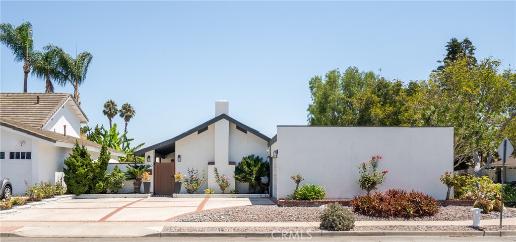 Welcome to 3460 San Rafael Cir – a masterfully renovated single-story oasis in the heart of Costa Mesa. Located in a quiet cul-de-sac within the sought-after Mesa Woods Neighborhood, this stunning 4-bedroom, 2-bathroom home spans 1,907 sq ft on a 6,652 sq ft lot. Completely reimagined in 2023, the home boasts brand new copper plumbing, electrical panel (with 240V for a future sauna), dual panoramic doors for seamless indoor/outdoor living, and a beautifully redone saltwater pool with new heater and system. The heart of the home is a chef’s dream kitchen featuring luxury appliances, a massive 11-ft island, abundant storage, and sleek finishes. Entertain in style with the open-concept layout flowing into the family and formal dining rooms, or step outside to the landscaped backyard oasis designed for relaxation. Retreat to a spacious primary suite with a huge walk-in closet and spa-like bathroom. The fully finished garage is insulated and drywalled with recessed lighting and epoxy floors—ideal for a home gym or workshop. Additional highlights include solar panels, central heating and A/C, new windows, luxury bathrooms, and premium fixtures throughout. Enjoy walking to nearby parks, quick freeway access, and proximity to world-class shopping and dining at South Coast Plaza. This turnkey property blends modern design, functionality, and lifestyle convenience—all just minutes from the best of Orange County.