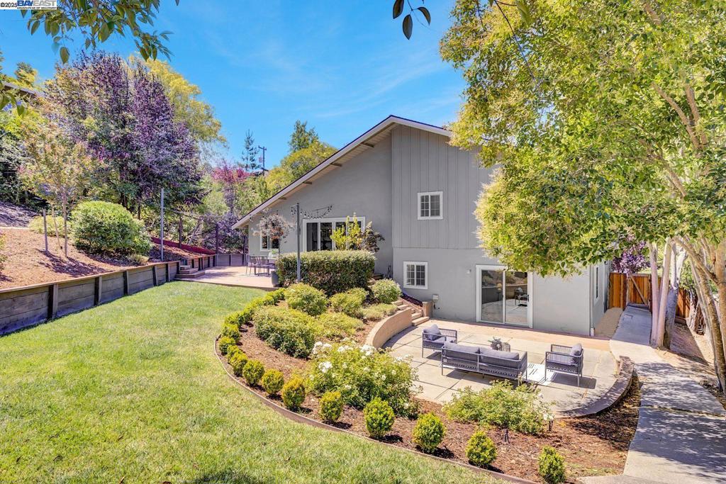 Discover this beautifully updated home on a nearly 1/3-acre lot in Lafayette’s highly sought-after Burton Valley neighborhood. Designed with indoor-outdoor living in mind, the open-concept main floor is anchored by a vaulted great room and a 10-foot panoramic sliding glass doors that seamlessly connect to your private, park-like backyard retreat. The custom kitchen is a showstopper, featuring timeless herringbone backsplash, quartz countertops and commercial-grade appliances—perfect for any home chef. Don’t miss the versatile lower level featuring additional living space, a dedicated laundry area, and a second sliding glass door offering direct access to the backyard Outside, enjoy expansive composite decking, a kids’ play structure, and ample space for entertaining or relaxing under the stars. Additional highlights include a newer, detached 120 sq. ft. studio—ideal as a home office, gym, or creative space and remodeled garage offers ample storage and wired for EV charging. Easy walkability to fields, trails and elementary school. This rare blend of luxury, privacy, and opportunity in one of Lafayette’s premier locations won’t last long. Don’t miss your chance to make it yours!