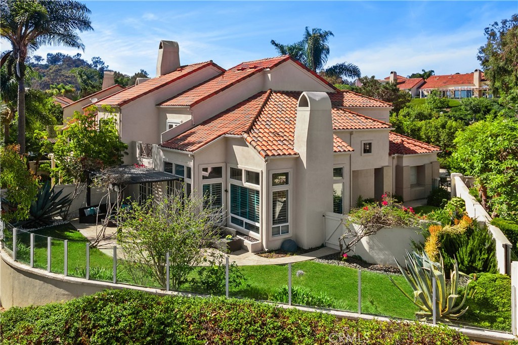 Live the good life in the coveted gated community of Siena and fall in love with this opened concept home that exceeds expectations! Upgraded three bedrooms (one downstairs with full bathroom) plus Loft is ideally located in the community and has exquisite finishes of hardwood and porcelain tiled floors, Carrara marble, and impressive windows that face a stunning view of hills, nature and gives you exceptional privacy! Right when you walk in through double glass doors, you are swept away by the soaring ceilings, gorgeous tiled to the ceiling fireplace and ceiling height windows! The kitchen is impressive and is open to living an indoor-outdoor lifestyle that is spacious, with a gorgeous Carrara marble countertop and backsplash, plus modern GE Monogram Stainless Steel appliances to include dual ovens, dishwasher, wine refrigerator, and a 5-gas burner stove! Primary bedroom has vaulted ceilings and dual doors that draw you to the deck that is perfect for coffee and views in the morning! Spa like bathroom has an extra-large shower in Carrara marble, stunning subway tile on the surrounding walls, and a stand-alone soaking tub plus shaker dual sink vanity with Carrara marble countertops! Upstairs the third spacious bedroom is en-suite with its own bathroom with marble showered/tub details and countertop! Garden oasis beckons enjoyment with a large patio under a pergola and grassy area that wraps around the corner of the home capturing hillside and nature views! Other noteworthy upgrades are newer Lenox AC, shutters, water softener and more. Gated Siena sits within coveted coastal Marina Hills and has its own pool/spa, front yard maintenance, however Siena residents also get to enjoy the main Marina Hill's clubhouse, Jr Olympic pool, tennis and pickleball courts, bocce ball and parks close by! And do not miss the ease in proximity to the Salt Creek trail to hike/bike to the Waldorf Hotel and Salt Creek beach! Don't miss out on living the good life of Siena!