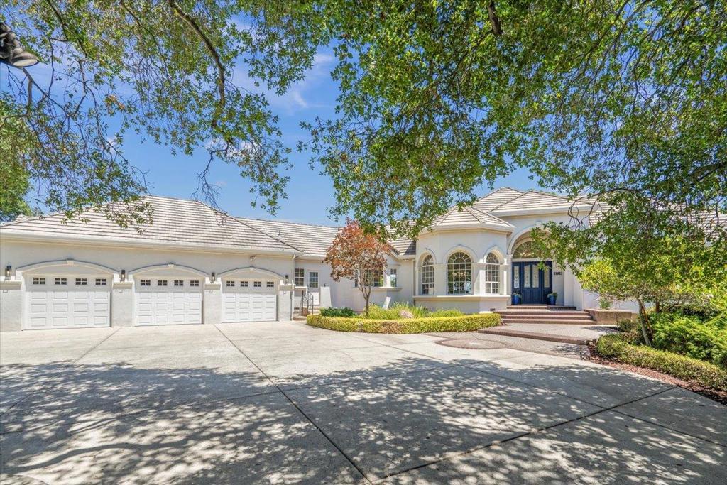 Rare opportunity in the desirable custom neighborhood of Country Estates. This lot was one of the first chosen and is special. 1.28 acres with gorgeous views over canopied stately oak trees, providing privacy, separation from neighbors, and opportunity for future development. A tree lined driveway brings you to an essentially single story home with a 3 car oversized garage and extra parking. Enter the home, and the expansive great room and wall of windows showcases city light, valley and mountain views. The formal dining room leads to an updated kitchen, island, quartz counters, built in Kitchen Aid refrigerator and large walk in pantry The casual eating space also has beautiful views & nearby French door to access the huge deck. The primary bedroom suite with views has deck access, a large walk in closet, double vanities, large soaking tub, separate shower & toilet room. A downstairs bonus room could be a family room/media room/recreation room & includes a 1/2 bath. One of the secondary bedrooms has an en suite 1/2 bath. The home has had recent updating including all new LED lighting, new light fixtures & ceiling fans, interior paint and wood flooring throughout the kitchen, great room and dining room. The 4th bedroom does not have a closet but is adjacent to a full bath.