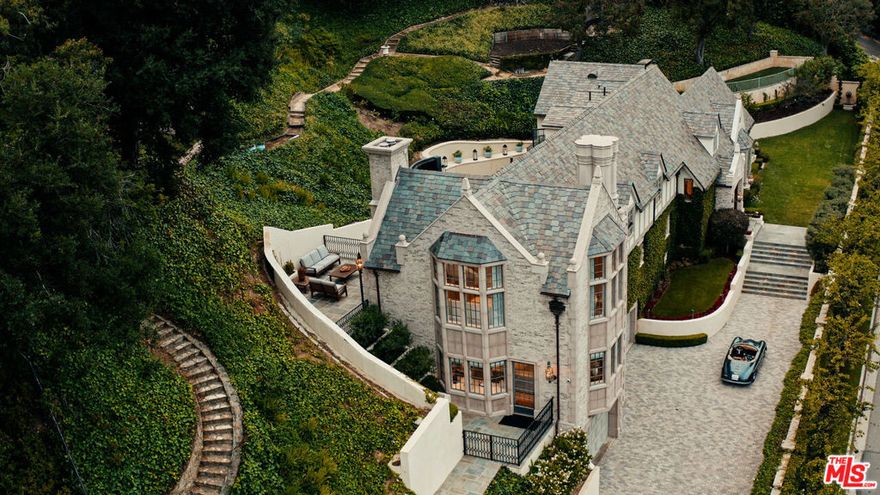 Some homes invite you in. Others take your breath away. 10950 Bellagio Road is the rare estate that delivers both effortlessly. The story begins at the gates, where a sweeping motor court sets the stage for what lies beyond. As you step through the front door, light pours across vaulted ceilings and rustic beams, dancing over a fireplace that anchors the formal living room. Beneath your feet, heated stone floors add a subtle touch of comfort that makes every step feel extraordinary. The kitchen, alive with character, is fitted with a La Cornue range and custom cabinetry. It's not just a place to cook, but to gather around the island for a glass of wine, or in the adjoining dining room where French doors open to your private oasis. Imagine a waterfall cascading 15 feet into a pool below, its sound carrying across every room in the house and terraces designed for long lunches, sunset dinners, or quiet yoga at dawn. Each space whispers relaxation, every corner invites you to linger. Tucked away in its own wing, the primary suite feels like the closing chapter of a perfect day. A marble spa bath, a two-story boutique-style closet, a fireplace to curl up beside, and a private patio overlooking the fairways. All the elements of retreat woven seamlessly together. The home continues with five guest suites, spaces for both celebration and solitude, a custom wine cellar, and even an elevator. And through it all, the sense of place is undeniable: Set within Lower Bel Air, overlooking the 15th fairway of The Bel Air Country Club, this immaculate residence captures the essence of one of the world's most coveted neighborhoods. This isn't just a home reborn, it's a story waiting for its next chapter. Tenant has the option to lease the staging furniture from the staging company directly.