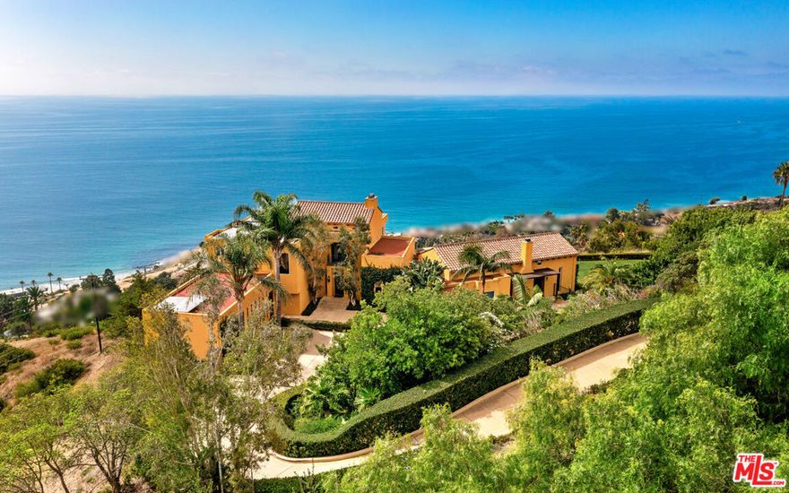 This private and gated adobe-style home offers sweeping ocean views and the valley below. The meticulously manicured grounds include a covered seating area on the patio and an adjacent lawn, ideal for entertaining. A firepit area and a resort-style pool with a waterfall complete the outdoor space.  Inside this home is a large living room bathed in natural light from a multitude of windows and patio doors that envelop the enviable views of Malibu. High ceilings, hardwood flooring, built-in speakers, and a cozy fireplace provide ambiance in the living room. Granite countertops, Scandinavian-style cabinetry, and commercial-grade appliances outfit the upscale kitchen. With a Viking range and double oven, plus an additional oven, and a walk-in pantry, this kitchen is equipped to serve large gatherings of family and friends.  This spacious home boasts a grand owner's suite plus four additional bedrooms. The owner's suite is outfitted with a stone fireplace, dual walk-in closets, and three sets of French doors that lead onto the expansive balcony that showcases sweeping views of the Pacific Ocean. The suite features dual bathrooms, a sauna, large walk-in, resort-style showers, and a bidet.  Off the main bedroom is a private office featuring built-in cabinetry and a desk, plus access to the balcony. The four additional bedrooms are ample and two have ensuite baths and ocean views.  This home also features a fully functional theatre room directly off the main living area, 220v power, a multi-zone A/C system, an alarm system, power shades, and a sprinkler system. Schedule your private showing today.