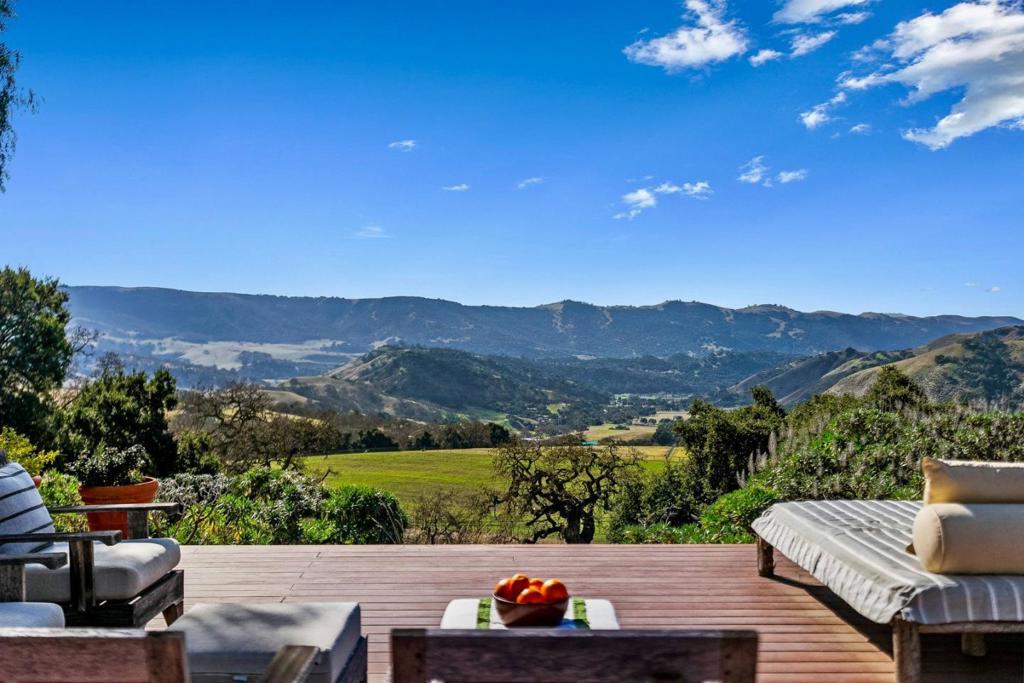 This is an incredible, turnkey home that overlooks the "Pastures of Heaven", which is the setting of John Steinbeck's book of short stories. The home is situated on 3.2 acres with beautiful, oak trees, 1,500 feet above sea level and and has expansive south facing views and a window to Monterey with its sparkling lights at night and the Pacific. The 3,000 sq ft, 4-bedroom, 2.5 bath home was built in 1964 and has been completely remodeled. It is replete with a gourmet kitchen, open living and dining room that walks out to a 400 square foot deck and fireplace with access to spectacular views of the valley below. The home has dark stained oak flooring and gas forced air heating and AC. There are a primary bedroom with an en-suite bathroom and door to the garden and three guest bedrooms that are all spacious and light. One bedroom is currently a home office but can be easily converted back to its original purpose. Additionally there is an 800 sq ft accessory building that could be turned into an ADU. This is country living at its finest with abundant wildlife and large surrounding ranches, while being very close to local amenities. Pebble Beach, Carmel & Monterey are all close by with world class golf and restaurants. Come and enjoy this wonderful lifestyle!
