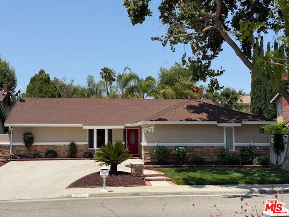 Discover your private retreat in the highly sought-after Valencia Meadows area! This beautifully renovated single-story home offers the perfect blend of classic charm and modern luxury, all within a block of the esteemed California Distinguished Meadows Elementary School and Valencia Meadows Park. Step inside and be greeted by an inviting open-concept layout, enhanced by elegant Tuscan travertine floors, crown molding, recessed lighting, and ceiling fans. The heart of this home is its renovated kitchen, featuring an island with bar seating, granite countertops, a large farm-style sink, stainless steel appliances, and convenient pull-out storage shelving. Enjoy effortless living with automated lighting throughout the house, controllable by voice command. The spacious primary suite boasts a luxuriously renovated bathroom with a sleek, glass-enclosed shower. The guest bathroom mirrors this sophistication, offering a stylish shower with chic finishes. Outside, your palm tree-lined backyard transforms into a private island escape, ideal for entertaining. It features a custom saltwater pool and spa, a well-maintained grassy area, and multiple inviting seating zones. The front yard showcases drought-tolerant landscaping complemented by a manicured lawn and beautiful rose bushes, alongside a convenient 2-car driveway. Located with easy access to the 5 Freeway, this home is just moments away from local restaurants, grocery stores, and recreational opportunities. Enjoy direct access to the famous Santa Clarita paseos, perfect for running, walking, scooters, and bikes. This exceptional home offers comfort, privacy, and an unparalleled Valencia lifestyle!
