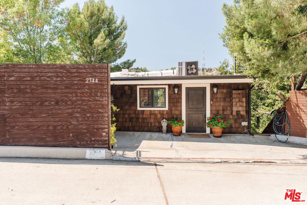 1958 Mid-Century Treehouse Retreat in Laurel Canyon. Tucked away on a quiet cul-de-sac in iconic Laurel Canyon, this 1958 mid-century modern treehouse offers over 1,800 square feet of stylish living space, expansive canyon views, and ultimate privacy with no neighbors on either side. Thoughtfully updated while preserving its architectural charm, the home features 3 bedrooms, 3.5 bathrooms, and a dedicated office. The main level welcomes you with a newly remodeled kitchen, an inviting living room, and floor-to-ceiling windows that flood the space with natural light. The large primary suite includes a brand-new bathroom and walk-in closet, complemented by a spacious guest bedroom and additional full bath. Timeless mid-century details, such as hardwood floors and wood-beamed ceilings enhance the home's warm, organic character. The lower level offers a second primary suite with en suite bath and walk-in closet, a separate office with half bath, and a full laundry room. Both levels open onto expansive balconies that span the length of the home, perfect for entertaining or embracing the indoor/outdoor California lifestyle. Additional outdoor areas include two newer patiosone at the entry and another at the bottom of the propertyproviding serene spots to relax or host. Situated on a desirable downslope lot with panoramic views, this tranquil escape is located within the highly sought-after Wonderland School District and offers easy access to the Hollywood Bowl, Sunset Strip, Runyon Canyon, and access to the Valley. A rare blend of architectural integrity, thoughtful updates, and peaceful canyon living.