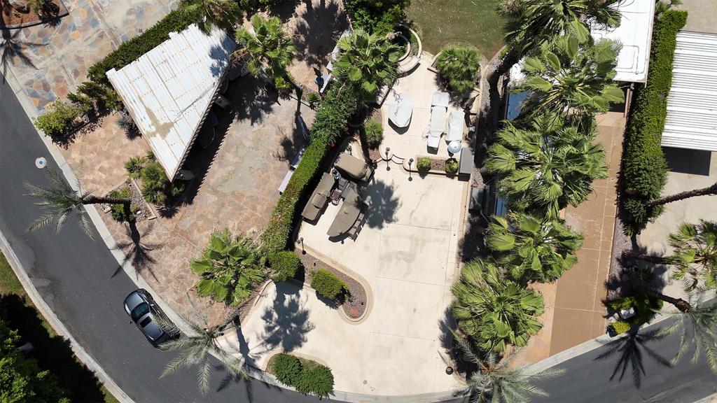 Discover one of the most desirable and private settings in the resort--Lot #358, a spacious 3,484 sq ft luxury RV lot tucked into the quiet northwest corner with stunning views overlooking Tee 10 of the golf course. Thoughtfully landscaped across two levels with raised planters, this lot offers both beauty and functionality. Your coach windshield faces north so your coach stays cooler!The elevated rear patio is ideal for outdoor entertaining, comfortably fitting two full furniture sets for relaxing or hosting under the desert sky. A well-equipped outdoor kitchen features a built-in bar with seating for four, double sink, refrigerator, oven, BBQ with rotisserie, garbage disposal, hot water heater, and a custom summer cover to protect it all. There's ample room for your 45' coach, multiple vehicles, and a golf cart--with a new lithium battery cart negotiable with the sale.Perimeter rope lighting adds ambiance, and the nearby pet area makes it perfect for animal lovers. Whether you're relaxing, entertaining, or enjoying resort amenities, Lot #358 offers a private, elevated experience that enhances the best of luxury RV living. Outdoor Resort Indio is a class-A motorcoach resort.‍