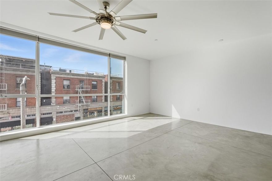 Experience the best of urban coastal living at Center Street Lofts! This modern two-bedroom, two-bath residence features high ceilings, polished concrete floors, and expansive industrial-style windows that flood the space with natural light and showcase views of downtown San Pedro and the Palos Verdes Hills. Freshly painted walls create a clean, modern canvas for your personal style. The open-concept layout blends living, dining, and kitchen spaces for effortless entertaining. Enjoy secure parking, elevator access, and an inviting outdoor community courtyard perfect for relaxing or gathering with neighbors. Steps from the new LA Waterfront / West Harbor, a transformative $800 million redevelopment bringing chef-driven restaurants, open-air dining, boutique shopping, live entertainment, and a scenic waterfront promenade to San Pedro. Modern loft living meets San Pedro’s waterfront renaissance and one of Southern California’s best coastal values. Don’t miss this opportunity!