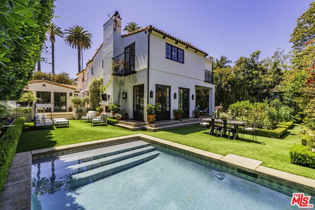 Exquisite Spanish colonial was owned by movie mogul Darryl F. Zanuck from the 1920's to 1940's during his founding of 20th Century Fox. The home has undergone a comprehensive restoration and rebuild, resulting in the perfect balance of period charm and modern amenities. Set behind gates & towering palms with lush, private grounds. Enter through the antique front door to a grand staircase and the soaring cross-trussed beams of the formal living room. The thoughtful redesign provides a more contemporary indoor-outdoor flow through countless French doors. A massive chef's kitchen, butler's pantry, huge island, marble counters, large informal dining area and an adjoining family room all open to the pool, spa, outdoor fireplace & pool house. A lavish master suite with fireplace, view terrace, large walk-in closet and his & her baths. Must be seen in person to fully appreciate the stunning finishes and attention to detail.