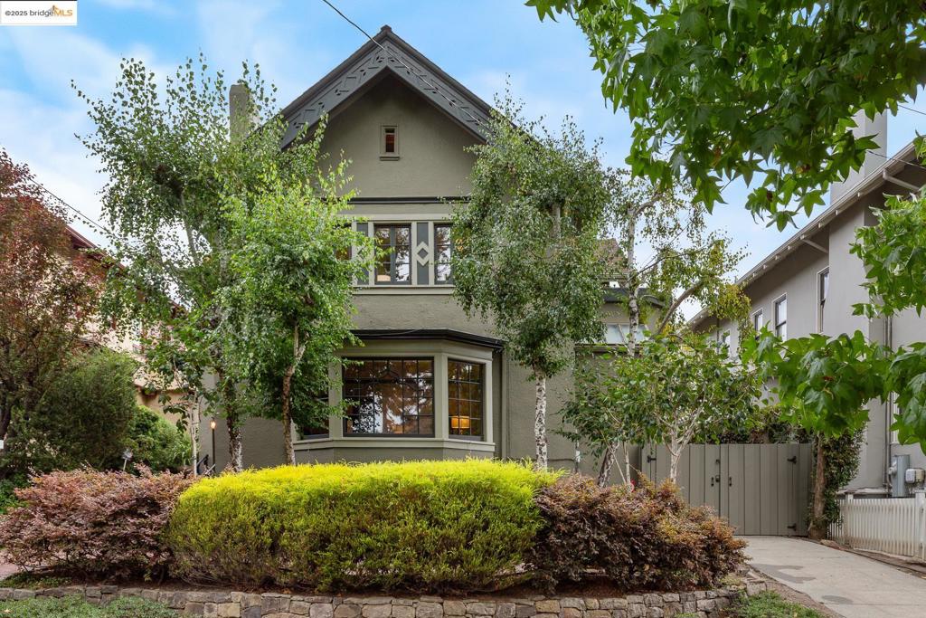 Welcome to this incredible Julia Morgan–designed home in Elmwood. You enter through a warm, Red wood-paneled foyer that leads to a spacious living room with a fireplace, a private office/den with built-in shelving and adjoining bath, a formal dining room with wainscoting, and a newly remodeled kitchen with half bath. The living room with a large Bay window is filled with natural light. The dining room opens to a generous family room, while the beautifully remodeled gourmet kitchen—with a center island, high-end Bosch appliances, and accordion doors—flows seamlessly to a lovely deck and landscaped backyard, perfect for entertaining. Original hardwood floors run throughout. Upstairs, you’ll find 4+ bedrooms and 2 bathrooms, including a serene primary suite that opens onto a large private deck. An additional sunroom features its own smaller deck, offering a perfect spot to step outside and recharge. The top floor attic is a versatile space with cork flooring, skylights, and windows—ideal for use as a guest retreat, art studio, gym, or playroom. Additional features include a two-car garage, secure gated entry, and a long driveway. Located in a highly desirable neighborhood, this home is just moments from College Ave shops, restaurants, and the Claremont Hotel.