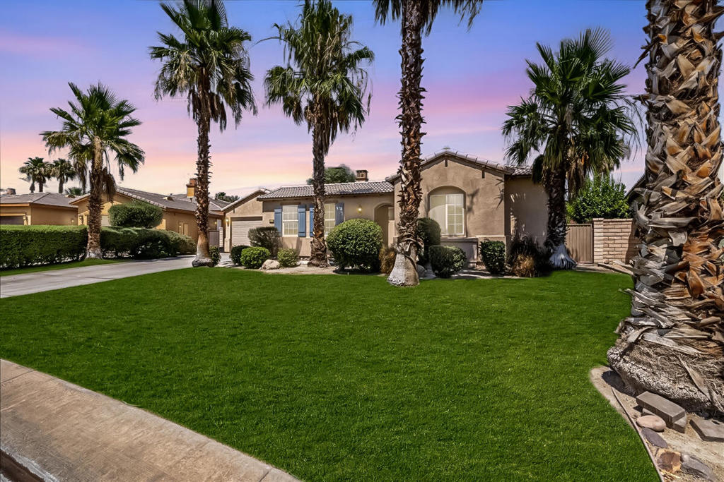Discover the perfect blend of luxury, comfort, and style in this exceptional 4-bedroom, 3.5-bath home, nestled within the prestigious gates of Paradiso in Indio. From the moment you arrive, the beautifully manicured front yard, expansive 3-car garage, and inviting courtyard with its cozy fireplace set the tone for what lies beyond. Step inside and experience an open, airy floor plan enhanced by elegant wood-look flooring and timeless neutral tones. The dramatic double-sided fireplace creates a warm, inviting ambiance between the formal dining room and the spacious great room -- ideal for entertaining. At the heart of the home, the chef's kitchen is a true showstopper, featuring a generous island, gleaming stainless steel appliances, and abundant cabinetry to meet all your culinary needs. Retreat to the luxurious primary suite, where you'll find a spa-inspired bath with a jetted tub, separate shower, dual vanities, and a walk-in closet designed to impress. The flexible office/den can easily transform into a fifth bedroom, media room, or private gym -- the choice is yours. Step outside to your personal oasis: a covered patio, sparkling pool, and soothing spa create the ultimate backdrop for unforgettable gatherings or quiet evenings under the stars. This is more than a home -- it's a lifestyle. Make it yours today and experience the best of Paradiso living.