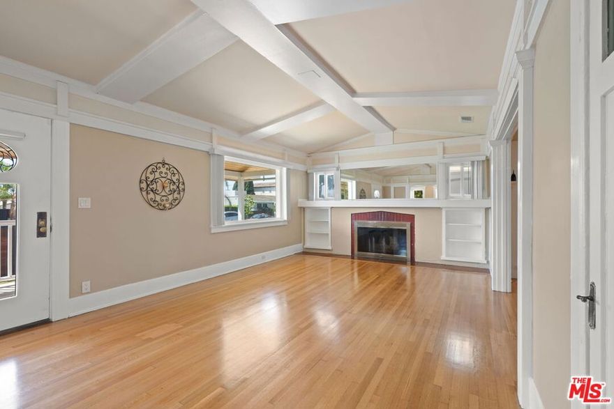 Rich historic character meets an abundance of private outdoor space at this 1913 Craftsman home on an extra-large, double-gated lot with two separate bonus units for extended family or extra income opportunity. Exposed beams, original hardwood floors, and a vintage wood-burning fireplace with built-in mantle lend style and warmth to the main living area. The large living and formal dining rooms open to a full kitchen, sunny breakfast nook, and an elongated wet bar or butler's pantry. There are two large bedrooms with walk-in closets, plus a third bedroom and dedicated bathroom at the rear of the home that can be separated into a private guest suite. The massive 8,866-sq-ft lot, kept private behind walls and two remote security gates, features a variety of different spaces: dedicated parking for six large vehicles, two grassy gated yards for the main home, a rear spa and sitting area for the main home, two storage structures, an outdoor laundry closet, and dedicated outdoor space for each of the two bonus units. The studio with high ceilings closest to the home is vacant, and an occupied one-bedroom unit can be vacated before the end of the year.