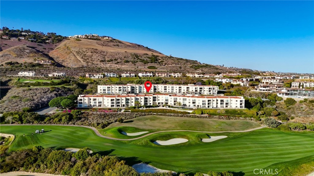 Over $200K in high-end upgrades elevate this ground-level 2BD/2BA condo in Ocean Terrace, one of Rancho Palos Verdes’ premier coastal communities. This approx. 1,476 sq ft unit features a spacious primary suite with a custom walk-in closet, large bedroom area, and a beautifully renovated en-suite bath with a modern vanity and LED touchscreen mirror. The second bathroom is equally well-appointed. The remodeled kitchen includes quartz counters, GE Café appliances, and sleek cabinetry. A cozy wet bar nook in the living room, complete with a wine refrigerator, adds charm and convenience next to the fireplace. A rare oversized balcony spans the length of the living space, offering panoramic ocean and Catalina views, perfect for indoor-outdoor entertaining. Bonus flex area is ideal for a home office or gym. Ocean Terrace offers resort-style amenities including a pool, spa, tennis courts, fitness center, and clubhouse, all located near scenic trails, Trump National Golf Course, and Terranea Resort.