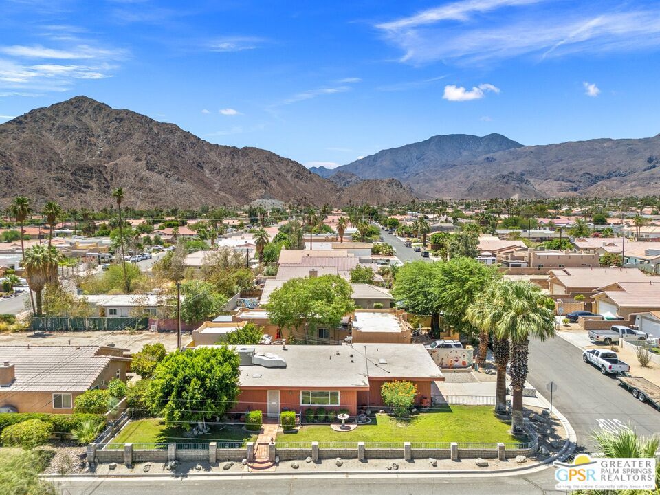 FIXER ALERT on corner lot in La Quinta Cove! Talk about POTENTIAL and just a short drive to the best of Old Town La Quinta. The open-concept living, dining, and kitchen areas create a spacious feel and work well with the great separation of bedrooms. The kitchen is filled with natural light and looks out onto the patio. The Primary Suite includes its own full bath for added privacy. Guest Bedroom Two features mountain views and sits next to a full bath shared with Guest Bedroom Three, which includes a fun mid-century style fireplace. There's a dedicated laundry area just off the kitchen and direct access to the two-car garage, which comes with built-in storage cabinets. Extra parking in the driveway adds even more convenience. Fantastic mountain views can also be enjoyed from the front porch. Be sure to take the Matterport Virtual Tour for a true sense of layout and flow. Fee Land (you own it) and no monthly HOA fee.