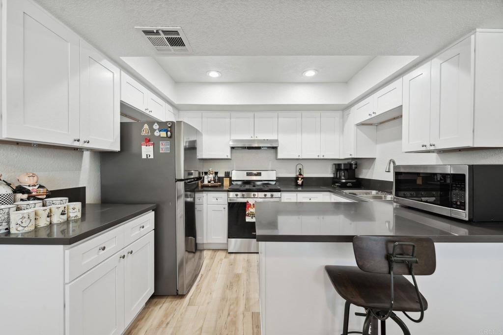 Beautifully remodeled townhouse in a gated community! All of the following upgrades were done within the last two years: gray quartz counters in the kitchen and bathrooms, new cabinets in the kitchen, new wood imitation vinyl flooring throughout the entire townhouse, fresh paint, new baseboards, new plantation shutters, new dual pane windows, new handrail and banister on the lower stairs, fully remodeled downstairs bathroom including a tile shower and glass enclosure, new water softener system, smart garage and new garage door, newly fenced patio. The garage also has a washer and dryer, electric car charging capability, and direct access to the home. Mountain view from two bedrooms, as well as a private sink and vanity where the primary bedroom connects to the upstairs bathroom for private bathroom access. Hall access to the upstairs bathroom also has its own sink and mirror vanity for the other two bedrooms. Central heat and AC with a smart thermostat, private enclosed patio with a natural gas line for a direct hookup to a grill, perfect for barbeques and entertaining. Excellent location, close enough to freeways for easy commuting, but far enough not to have any freeway noise. Conveniently located near shopping centers, restaurants, and the hospital. Well maintained, gated community with a pool and spa. This townhouse will not be on the market long - hurry to see it while you can!