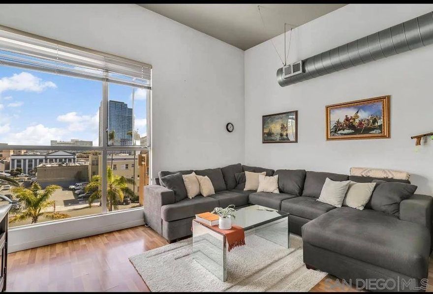 The Lofts @ 777 Sixth Avenue is the perfect location for Downtown living. Its located adjacent to numerous luxury shopping, restaurants, and nightlife venues. A short walk to Gas Lamp, the Waterfront, and Petco Park. This is a top floor unit that features high ceilings that provides an open air feeling. The open floor plan where the living room, dining area and kitchen flow seamlessly together maximizes the living space. The kitchen features plenty of cabinets and counter space for all your cooking and entertaining needs. It offers extra open shelf space with an eat-at center island. There is a private bedroom set apart as a partial loft and lots of creative storage areas. The in-unit stackable washer and dryer offers privacy and convenience. There are great views of the city lights from the living room and common areas. This is a secure gated community with a guard that is located in the heart of Downtown. Very low HOA fees compared to the market, but still provides a fully-equipped fitness center and beautiful common area. The location of this unit as well as the layout, condition, and charm make this unit highly desirable if you want to enjoy all that San Diego has to offer. Pictures are from a previous listing. Flooring has been changed and the kitchen cabinets need repaired on one side.