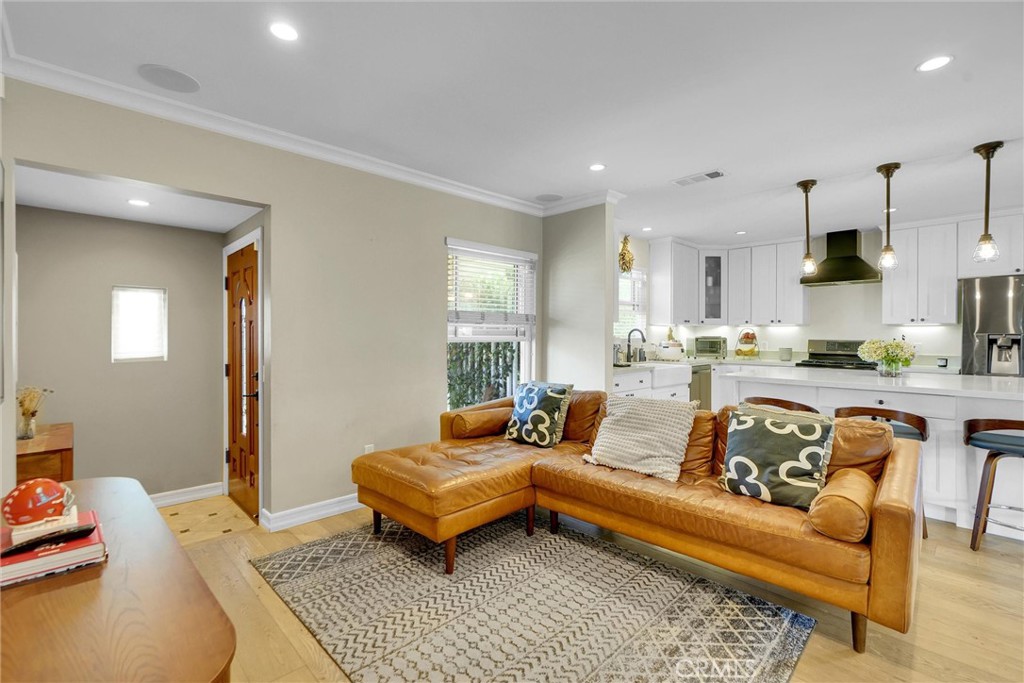 Most beautiful 3 bedroom 2.5 bath,salt water pool home in Lake Balboa adjacent neighborhood ready for the most discriminating and sophisticated purchaser. The completely rebuilt, remodeled and light and bright redesigned home is in a class by itself in terms of design, quality of materials, and presentation. The rosebush rimed grassy front yard invites you to the formal entry and beautiful European French Oak Wood floors, recessed lights throughout living room/kitchen and dining room providing flexible space in the open concept design.The kitchen includes an oversized island with a built-in beverage fridge and microwave nook, quartz countertops, farmhouse sink, under cabinet dimmer lights, plus plenty of slow closing cabinetry, LG black stainless-steel appliances and range hood. Conveniently located large walk in pantry and laundry room with Italian porcelain flooring close by. Crown molding throughout, recessed dimmer lighting and fans in every bedroom. All bathrooms have automatic exhaust fans with timed light switches providing energy efficiency. The living room has 5 built-in surround sound speaker, Nest Thermostat, paid alarm equipment, and the home has New solar panels and New Tesla car charger. Additionally, there is a huge master suite with a custom walk-in closet that includes drawers, shelving and double racks. Master bath features rock flooring and a custom walk in shower. The two other bedrooms are ample with large closets for storage and hallway bathroom with tub. Beveled french doors lead to the showstopper backyard which is an entertainers paradise. Newer alumawood patio with recessed lighting, fan, tv set and built in speakers plus gas hookup for your favorite BBQ. Gorgeous heated saltwater, pool which goes 5.5 feet deep, with 10 spa jets, a wraparound bench, color changing LED lights, a waterfall flowing over a gas fireplace, pool heater and wireless pool equipment. A backyard paradise that you may never want to leave!! Newer side fence and solid rear wall, privacy hedges and 2-car detached garage. Easy westside/downtown access. This home is a 10+ if you need a family retreat or entertainer's dream you can have both here!!